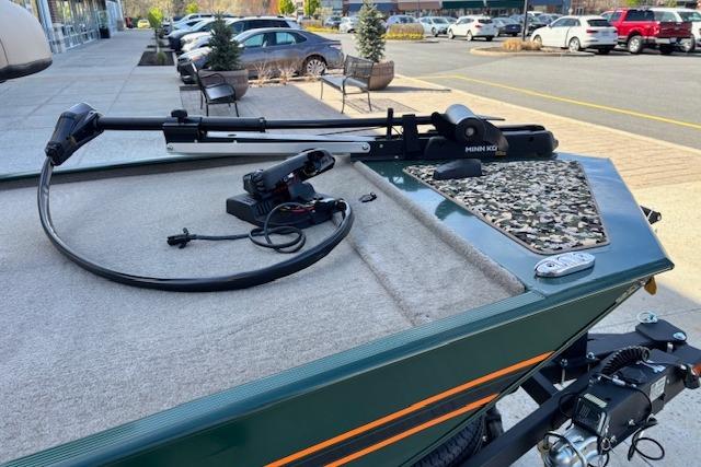 2026 Tracker Bass Tracker Classic Limited boat with trolling motor in a parking lot.