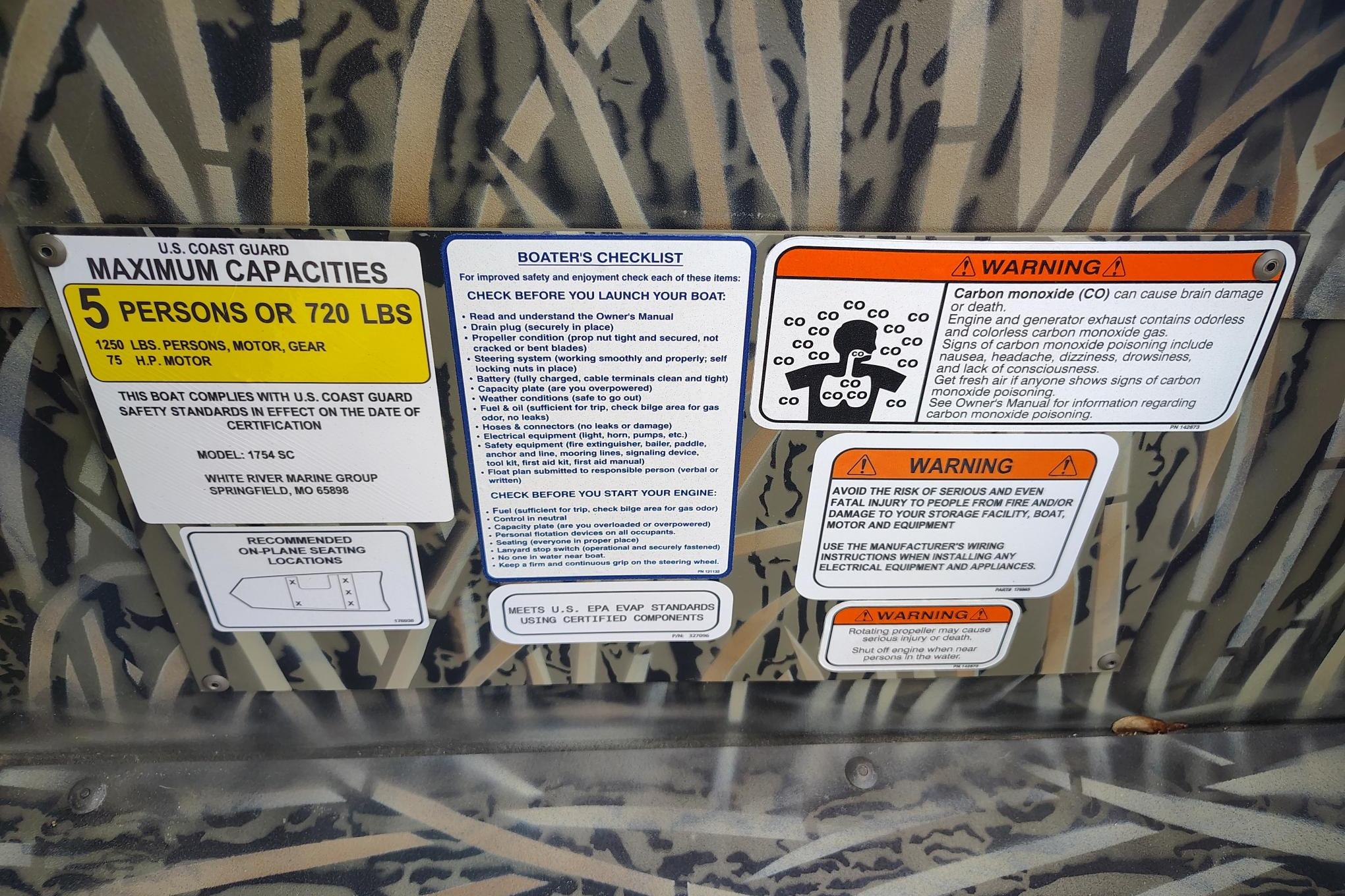 2026 Tracker Grizzly 1754 SC boat safety labels and warnings, including capacity and carbon monoxide risks.