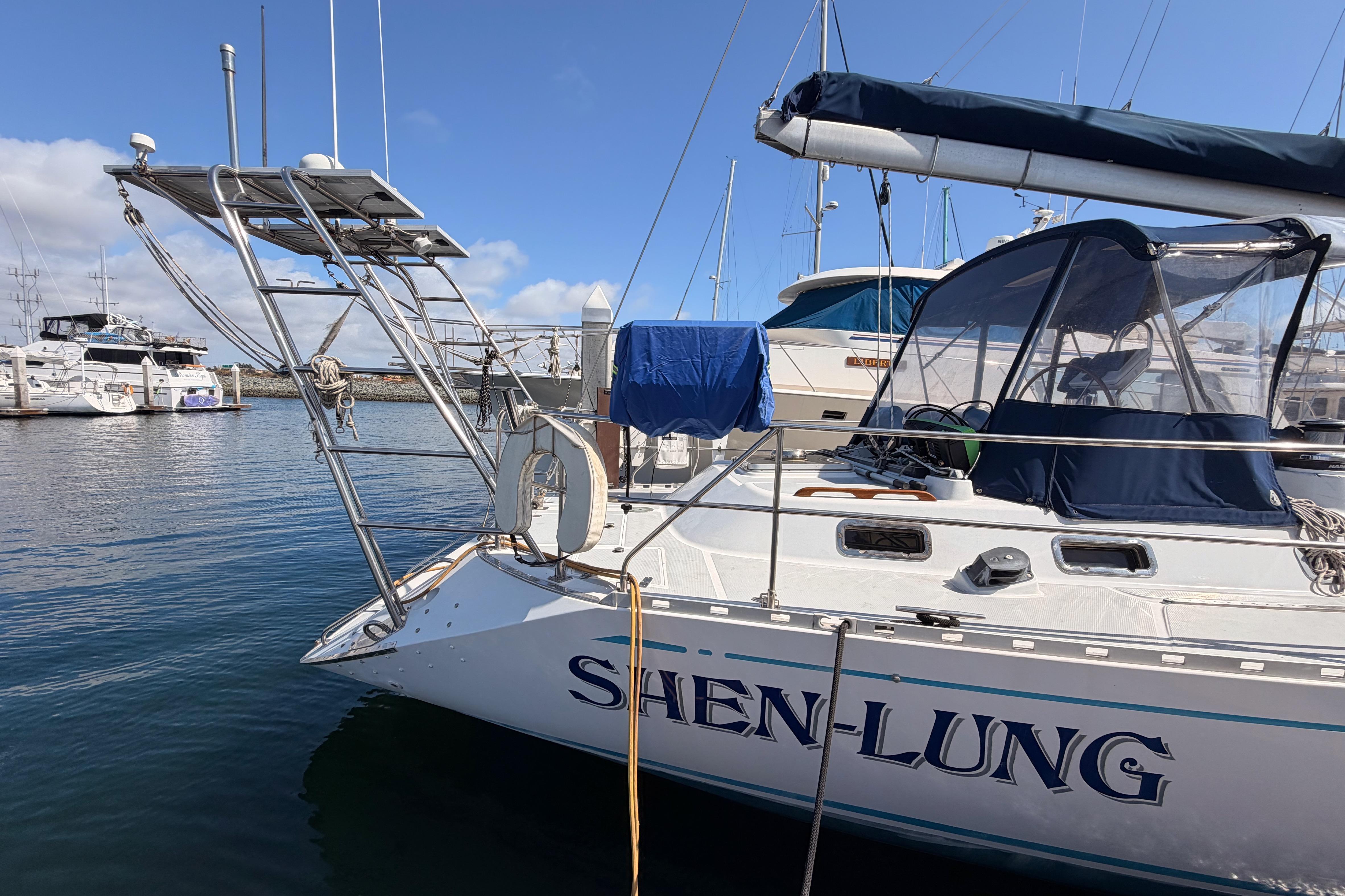 Sailboat "Shen-Lung" docked, Hylas 51 model, 1991, in a marina with clear skies.