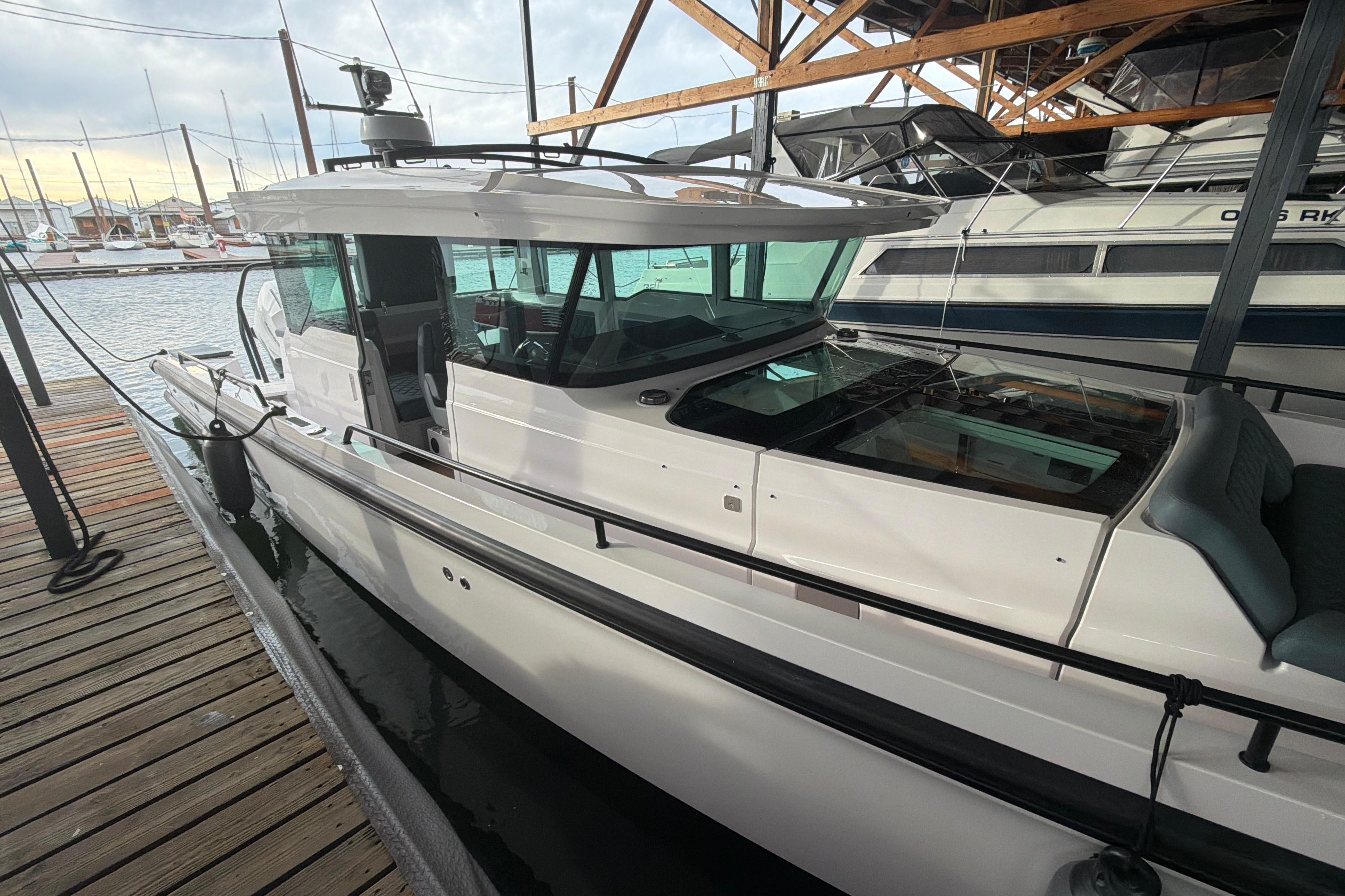 2022 Axopar Brabus 37 XC Cross Cabin docked at marina, showcasing sleek design.