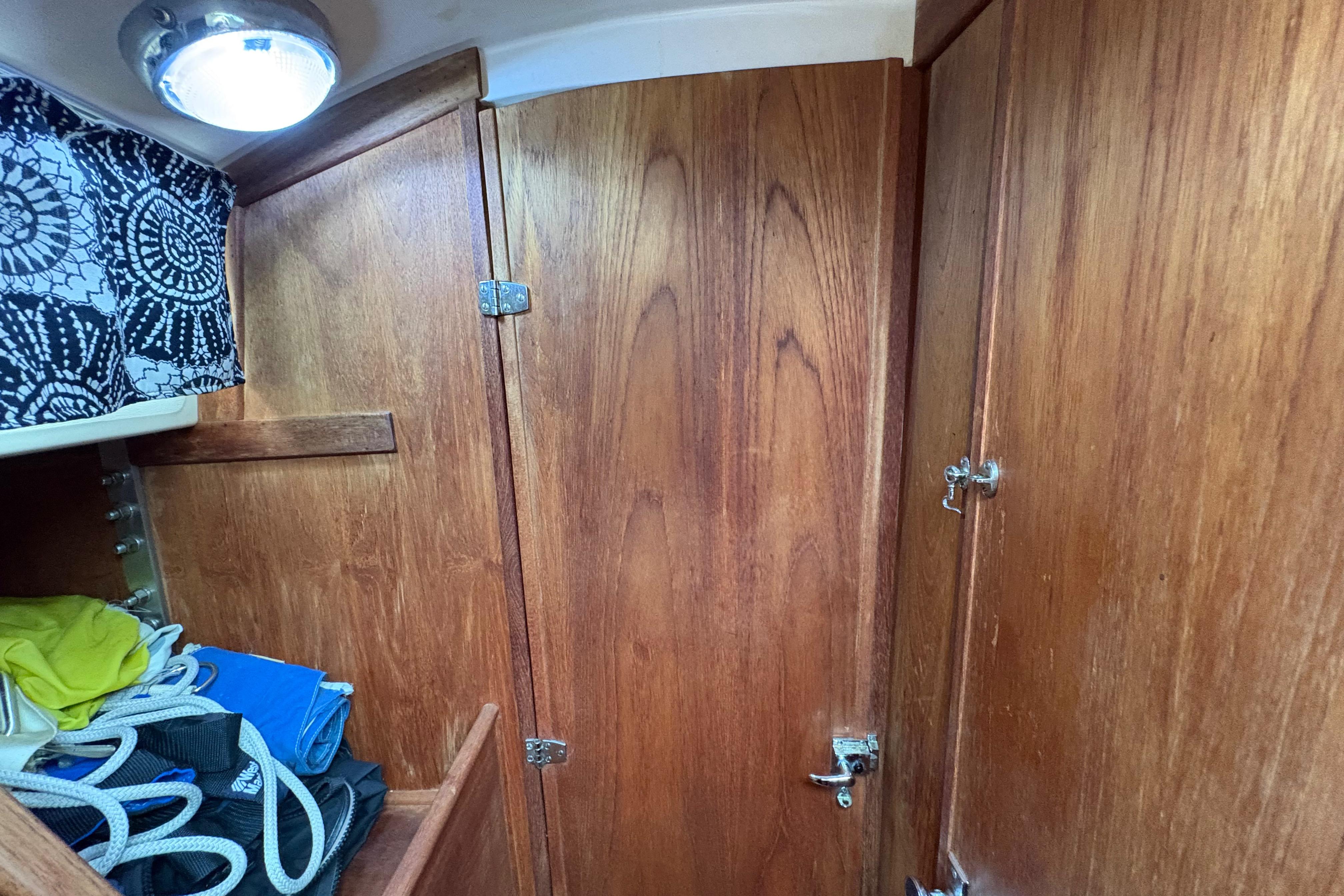 Interior of 1981 Sabre 31 sailboat with wooden cabinetry and storage space.