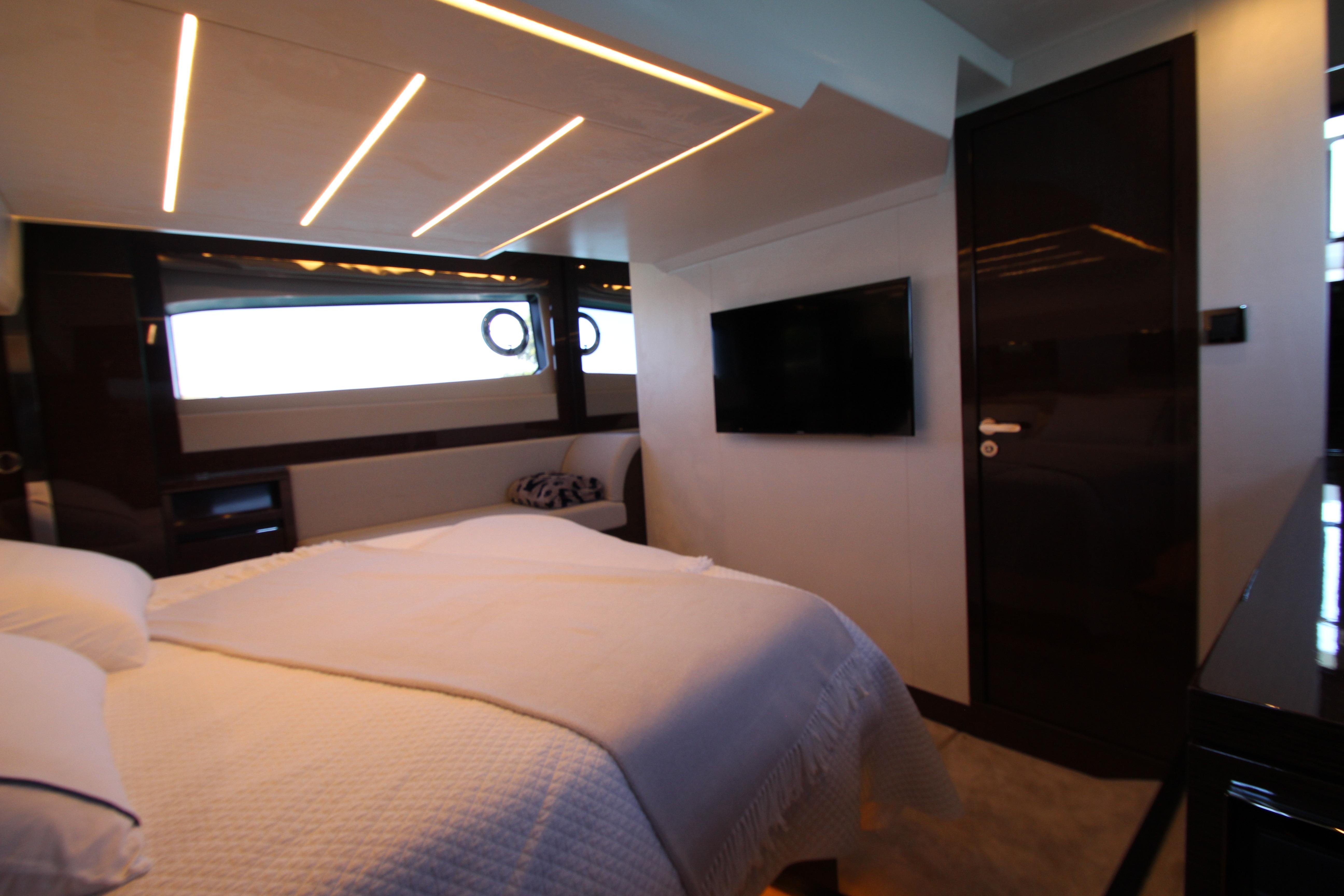 Luxurious bedroom interior of 2022 Prestige 520 yacht with modern lighting and sleek design.