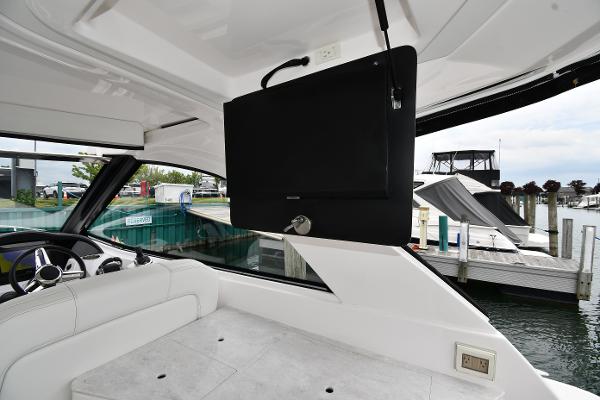2021 Regal 35 Sport Coupe interior with TV, white seating, and marina view.