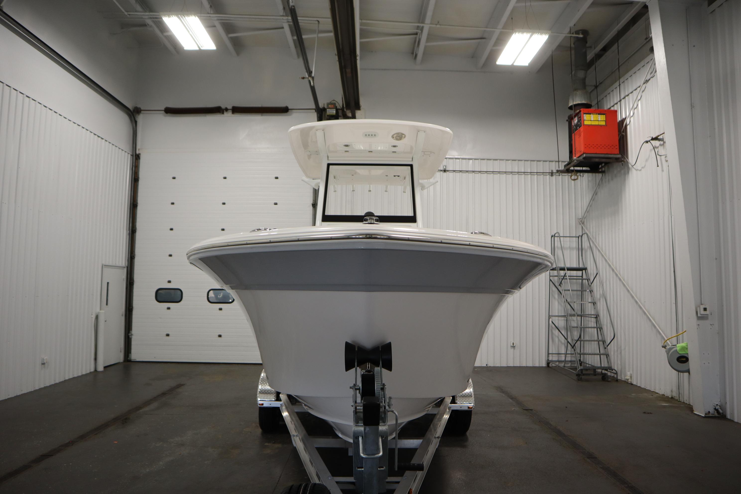 2026 Sea Fox 228 Commander boat in a spacious indoor storage facility.
