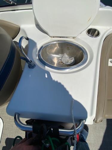 2005 Bayliner 249 SD boat sink with faucet and cup holder on deck.
