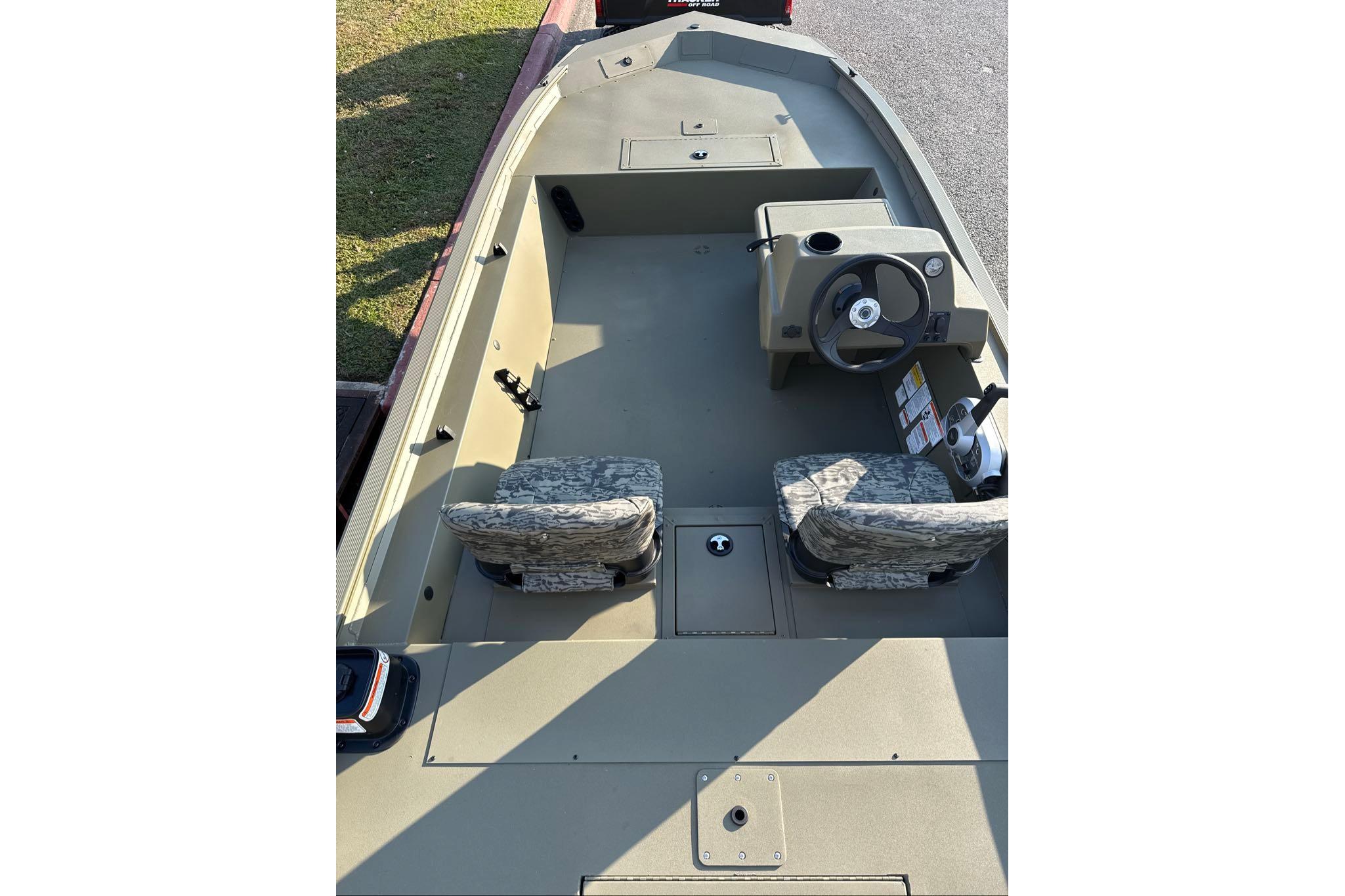 2026 Tracker Grizzly 1754 SC boat interior with dual camo seats and steering console.