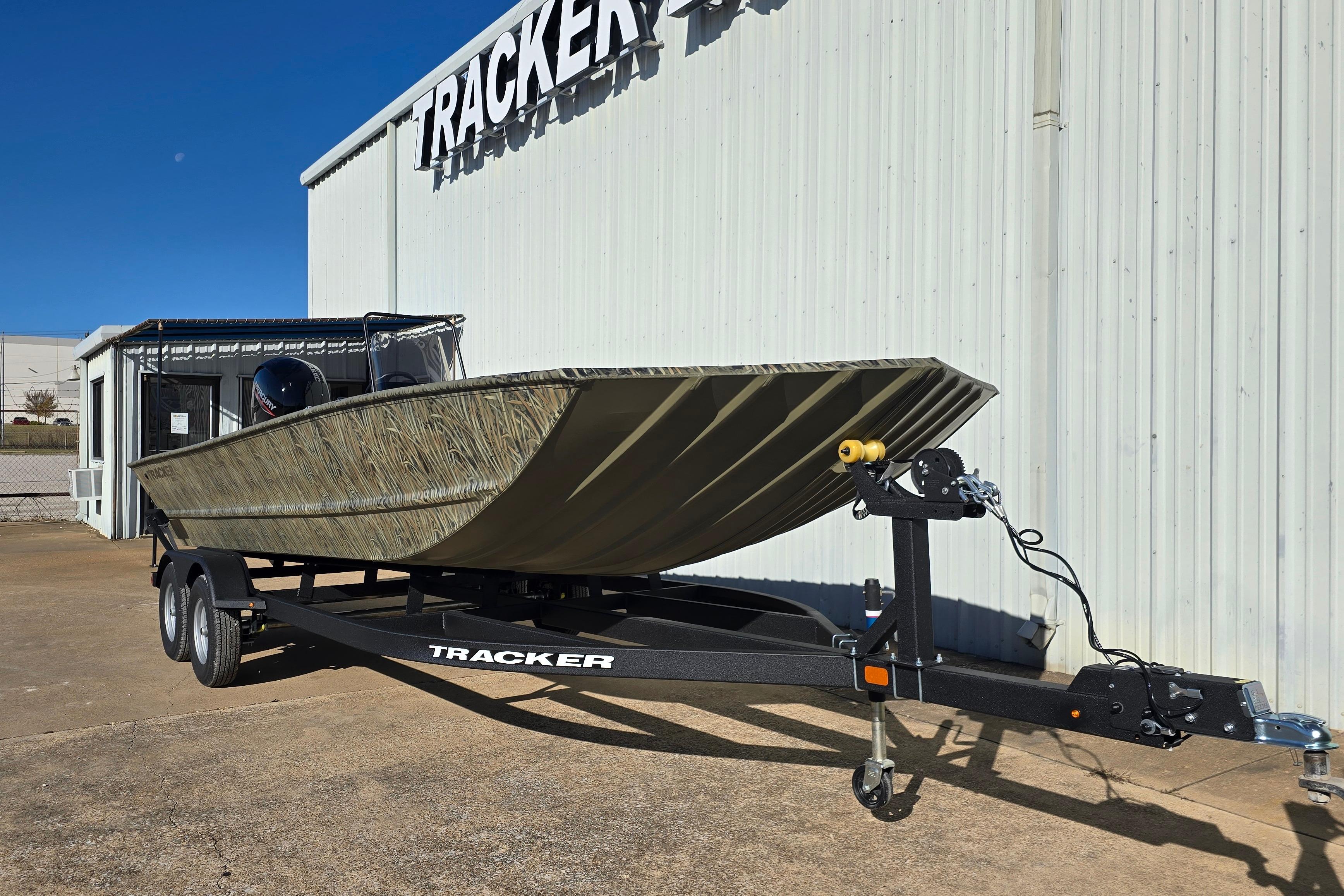 2026 Tracker Grizzly 2072 CC boat on trailer outside dealership.