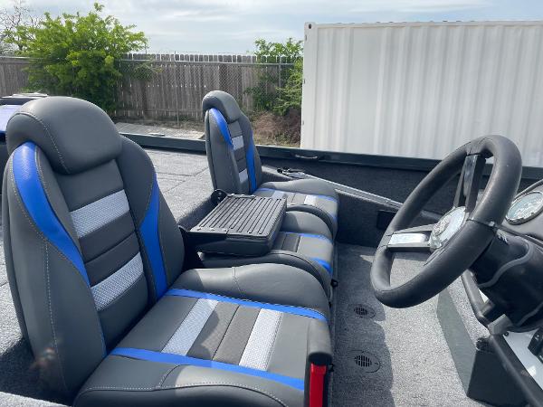 2025 Ranger RT188P boat interior with blue and gray seats, steering wheel, and console.