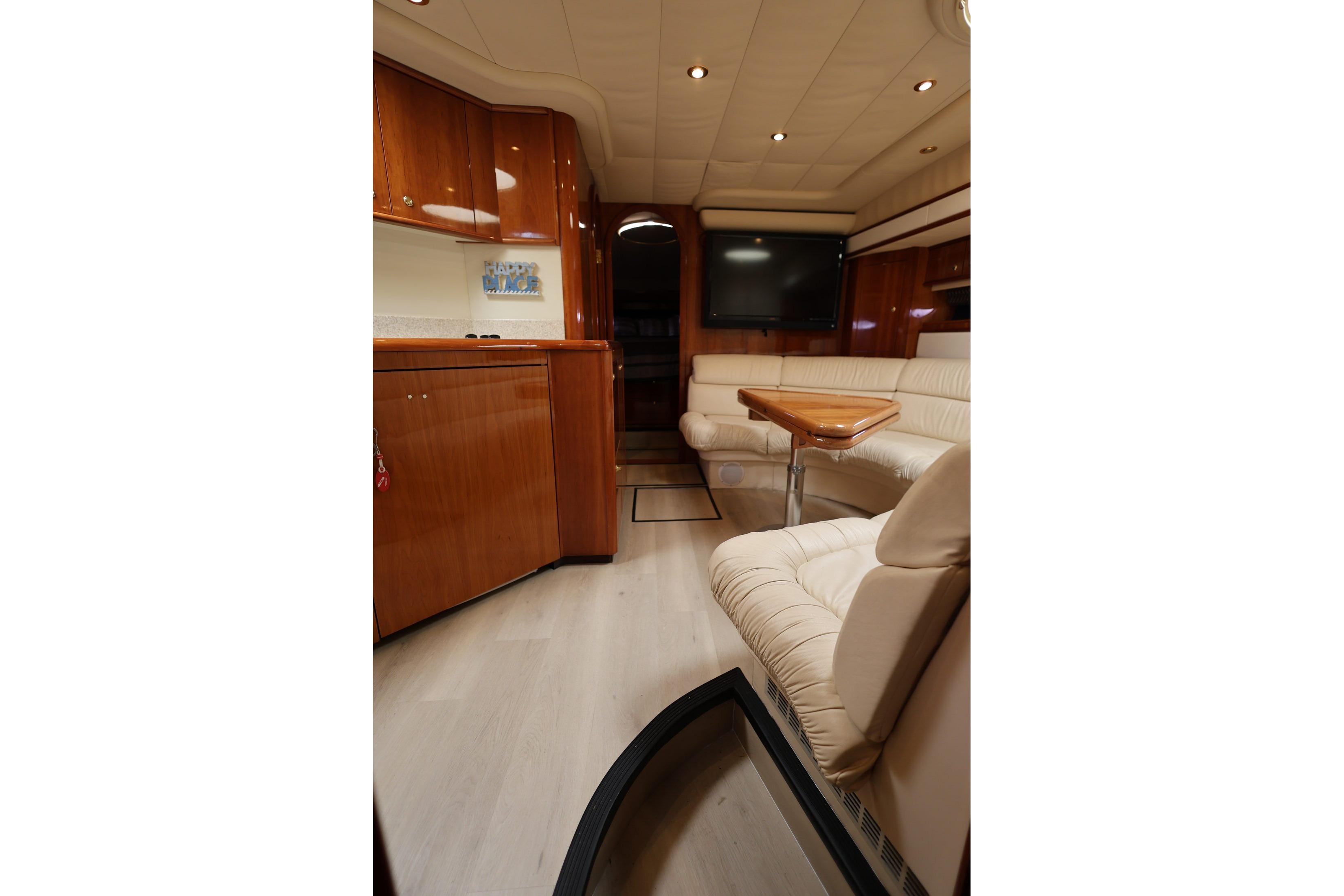 Luxurious interior of 1999 Neptunus 54 Express yacht with elegant seating and wood finishes.