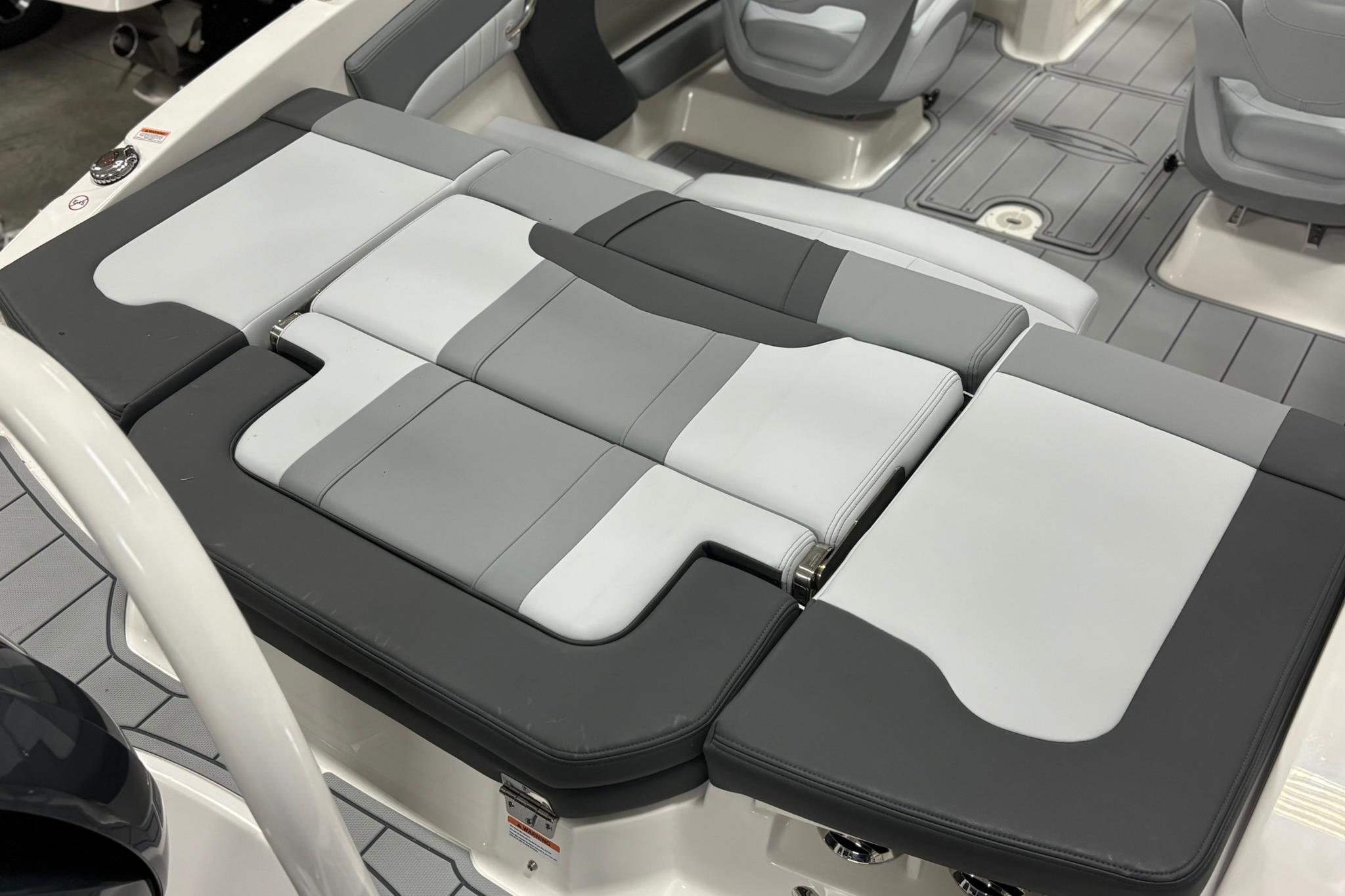 2026 Chaparral 21 SSi OB boat interior with gray and white cushioned seating.