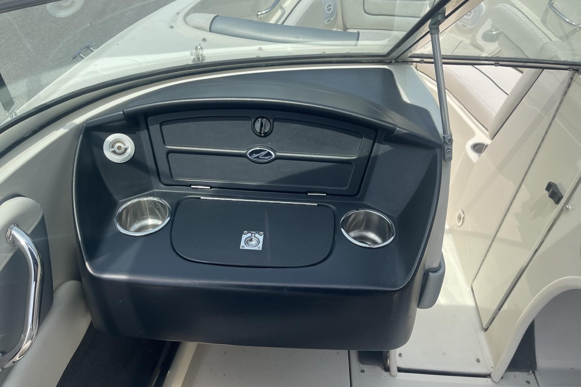 2010 Sea Ray 230 Bow Rider Select dashboard with cup holders and storage compartments.