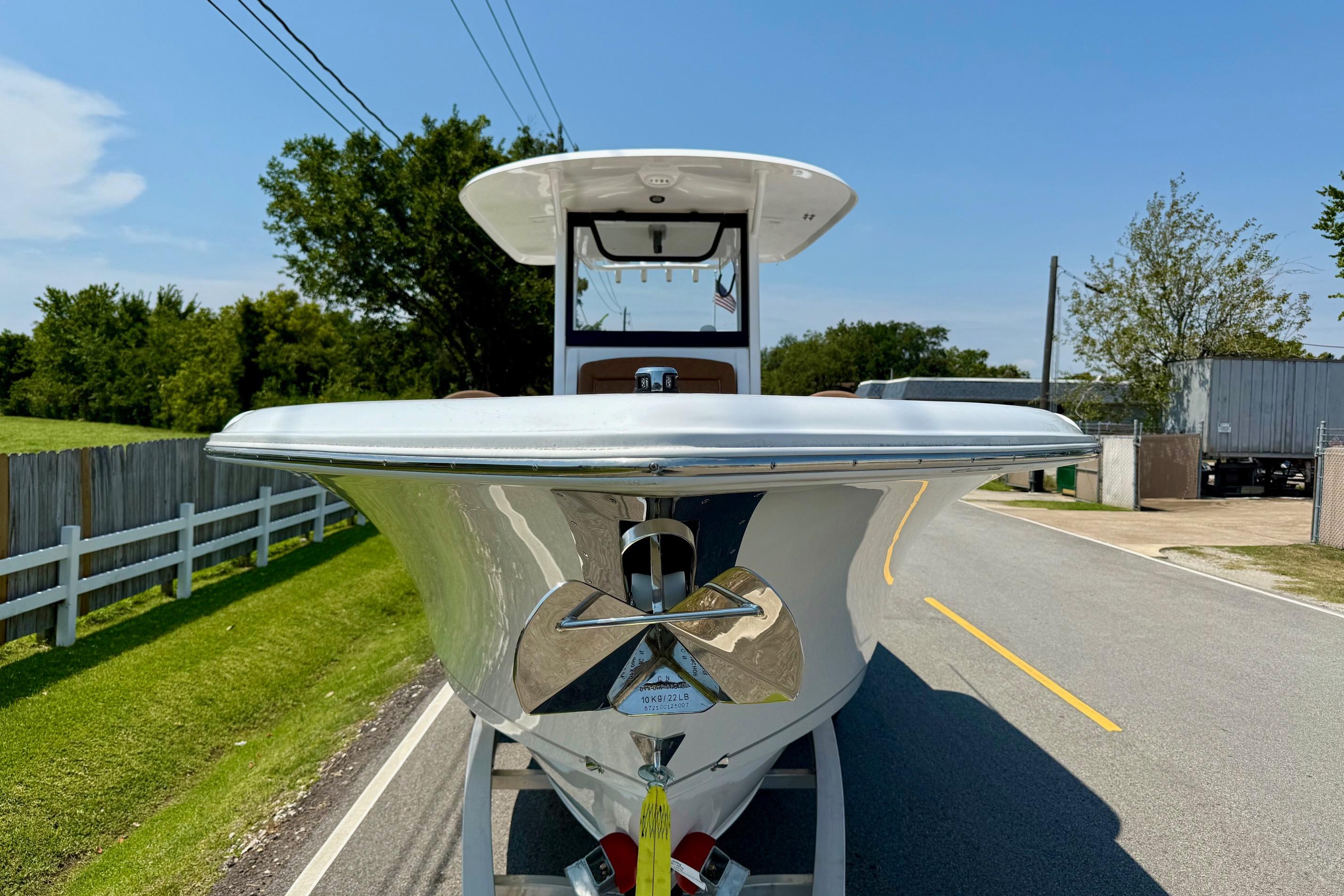 2026 Sea Hunt Ultra 305 SE boat on a road, front view, sunny day.