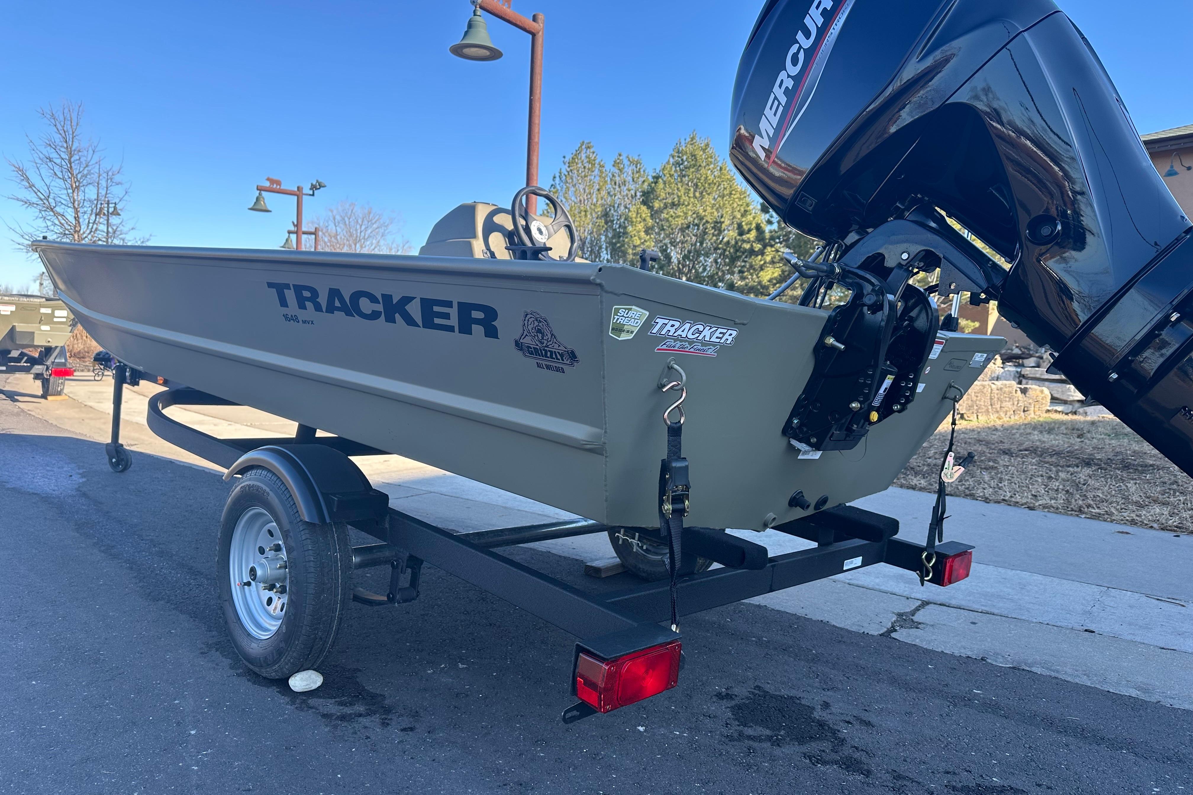 2026 Tracker Grizzly 1648 SC boat on trailer with Mercury outboard motor.