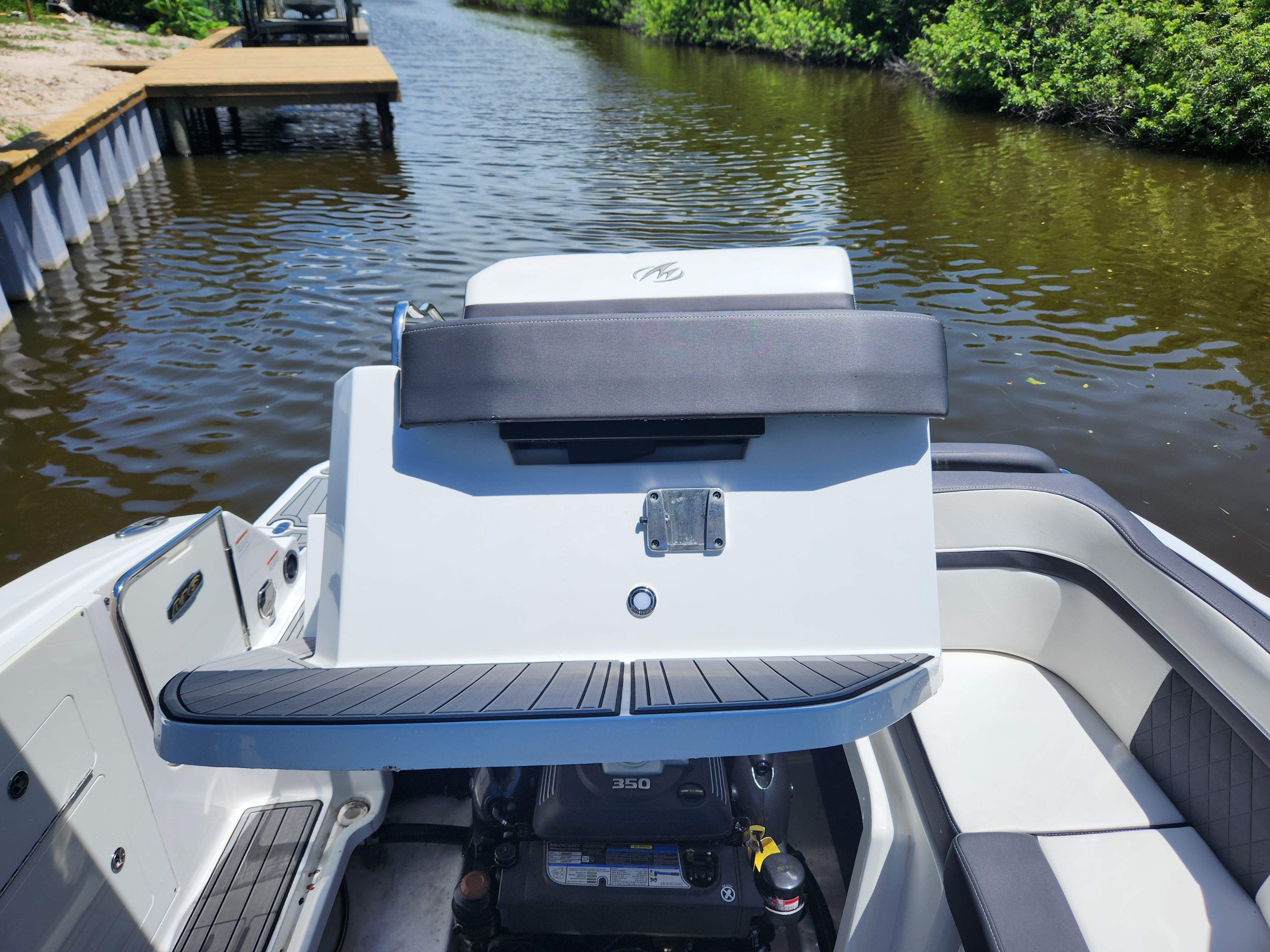 The image shows the stern of a 2021 Monterey M6 boat on a calm waterway.