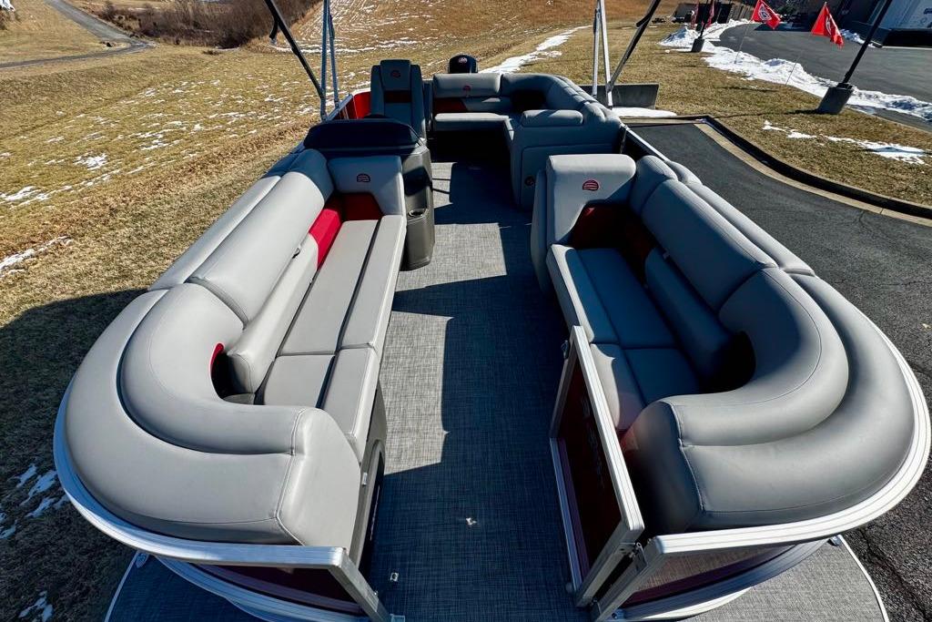 2026 Sun Tracker Party Barge 20 DLX with spacious seating on a sunny day.