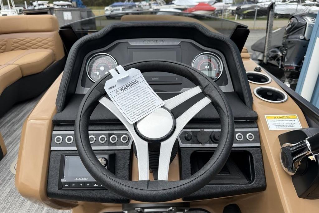 Steering console of 2026 Godfrey Monaco 235 SFLC iMPACT boat with gauges and controls.