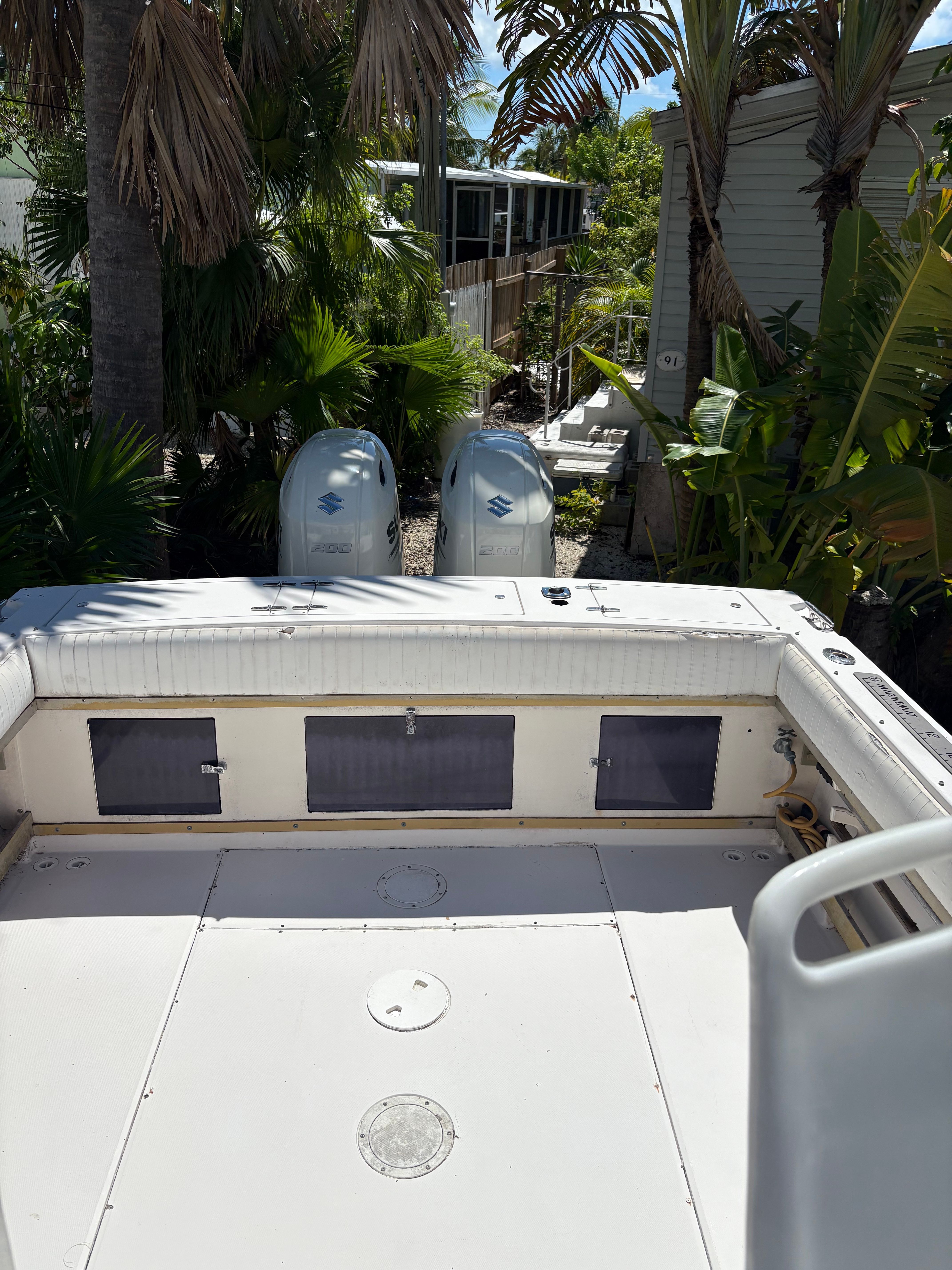 The image shows the stern of a Grady-White Sailfish boat with two outboard engines.