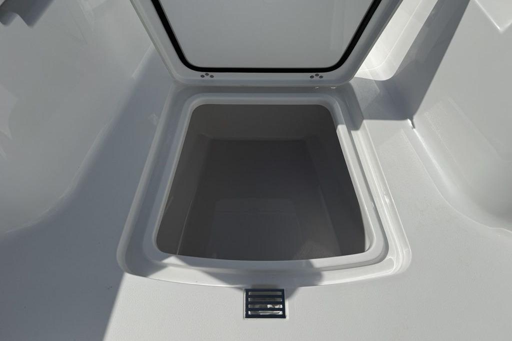 2026 Sportsman Open 252 Center Console storage compartment, open and empty.