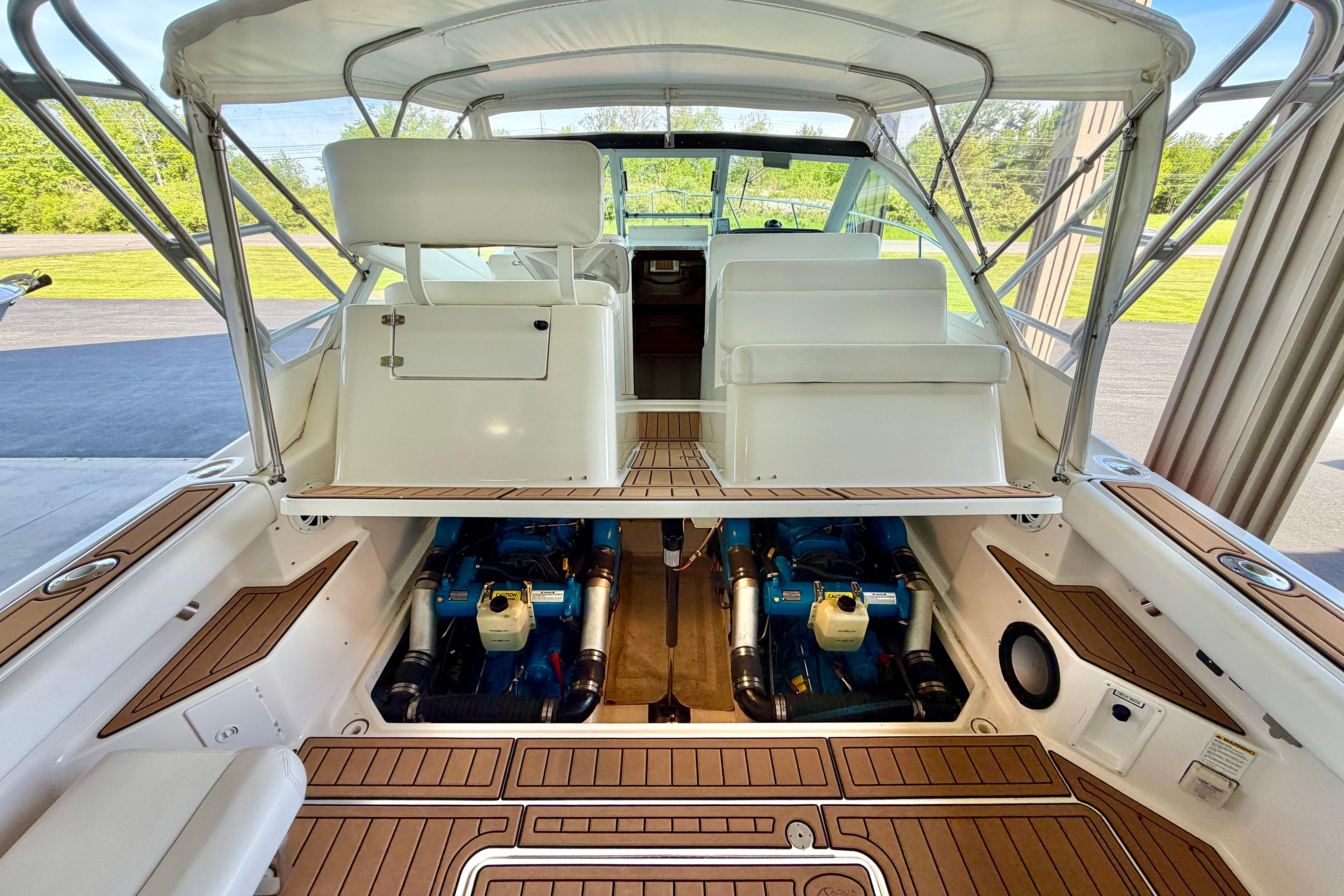 1999 Tiara Yachts 2900 Coronet interior with open engine compartment and seating area.