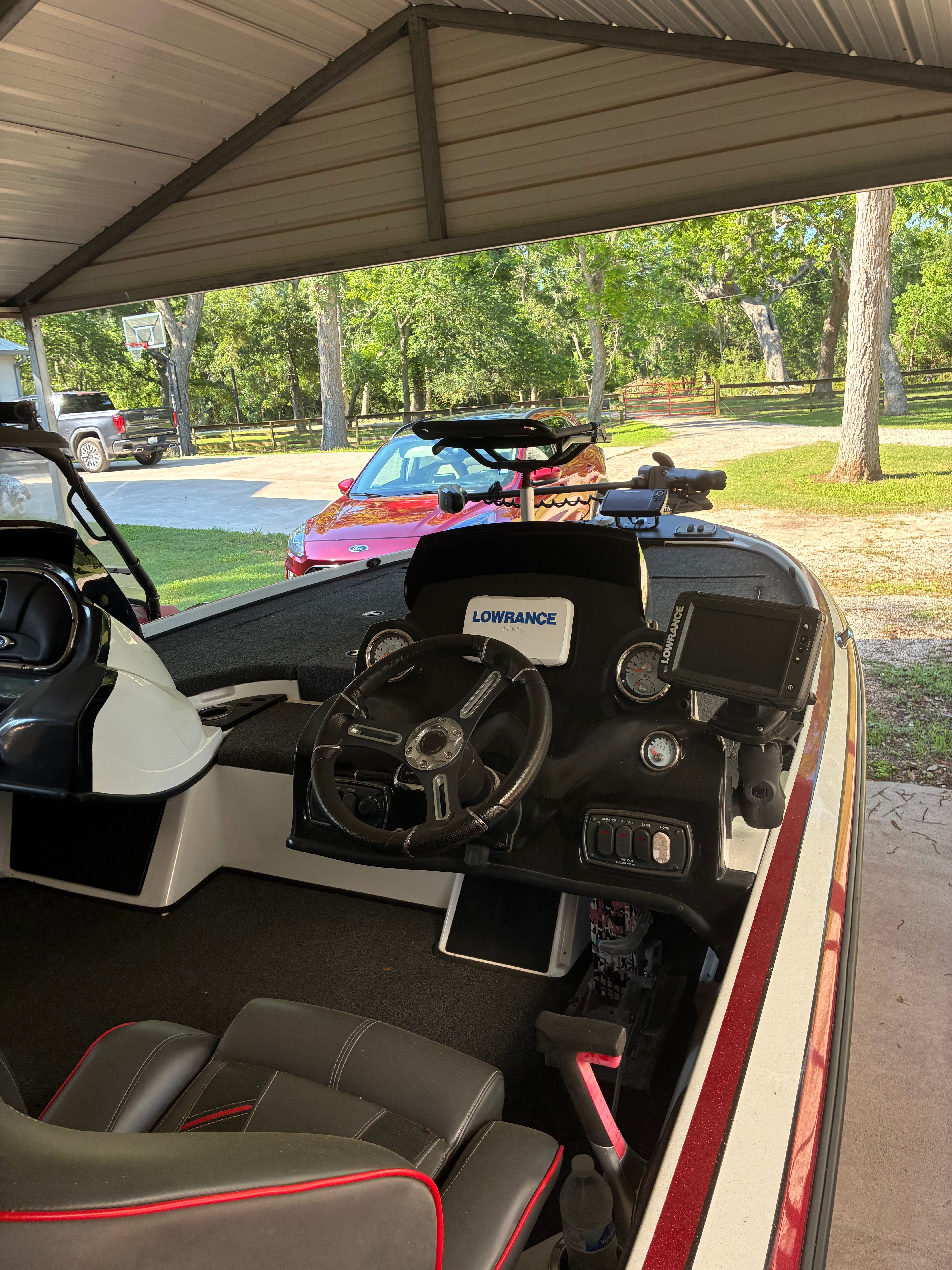 A 2019 Nitro Z18 boat is parked under a carport.