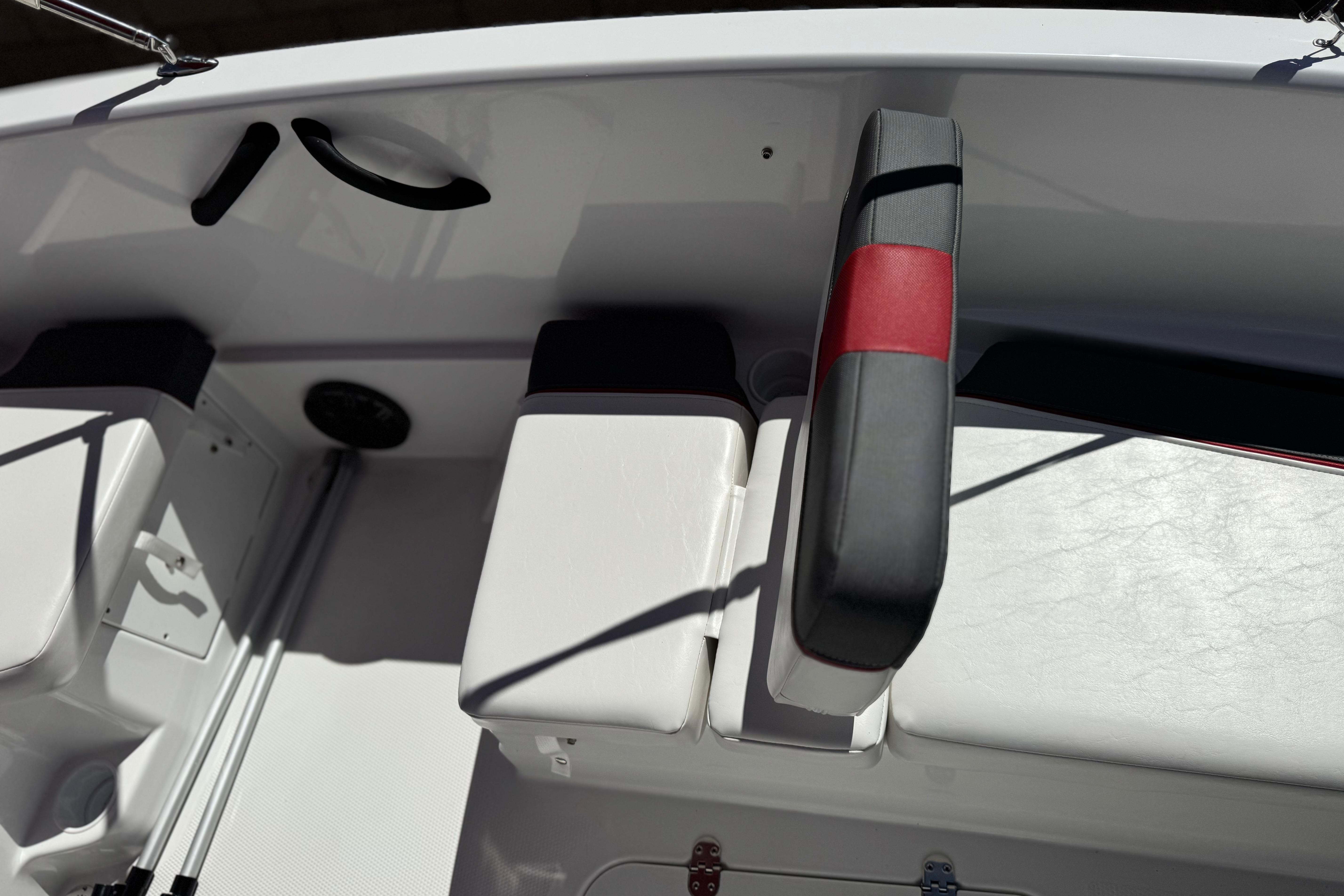 Interior of 2024 Tahoe T16 boat featuring white seating and red accents.