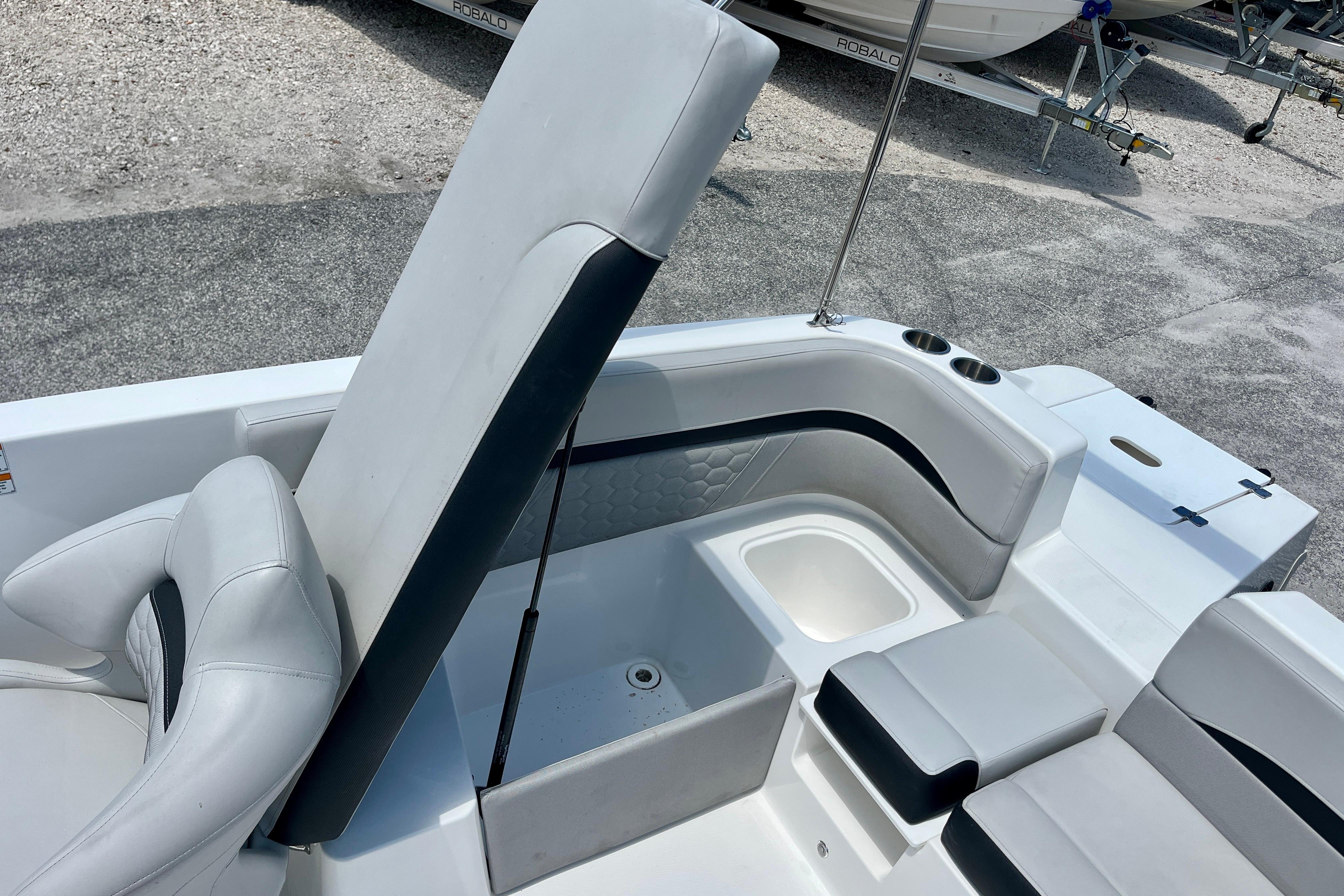 2024 Hurricane Sundeck Sport 218 OB boat interior with white seating and storage compartments.