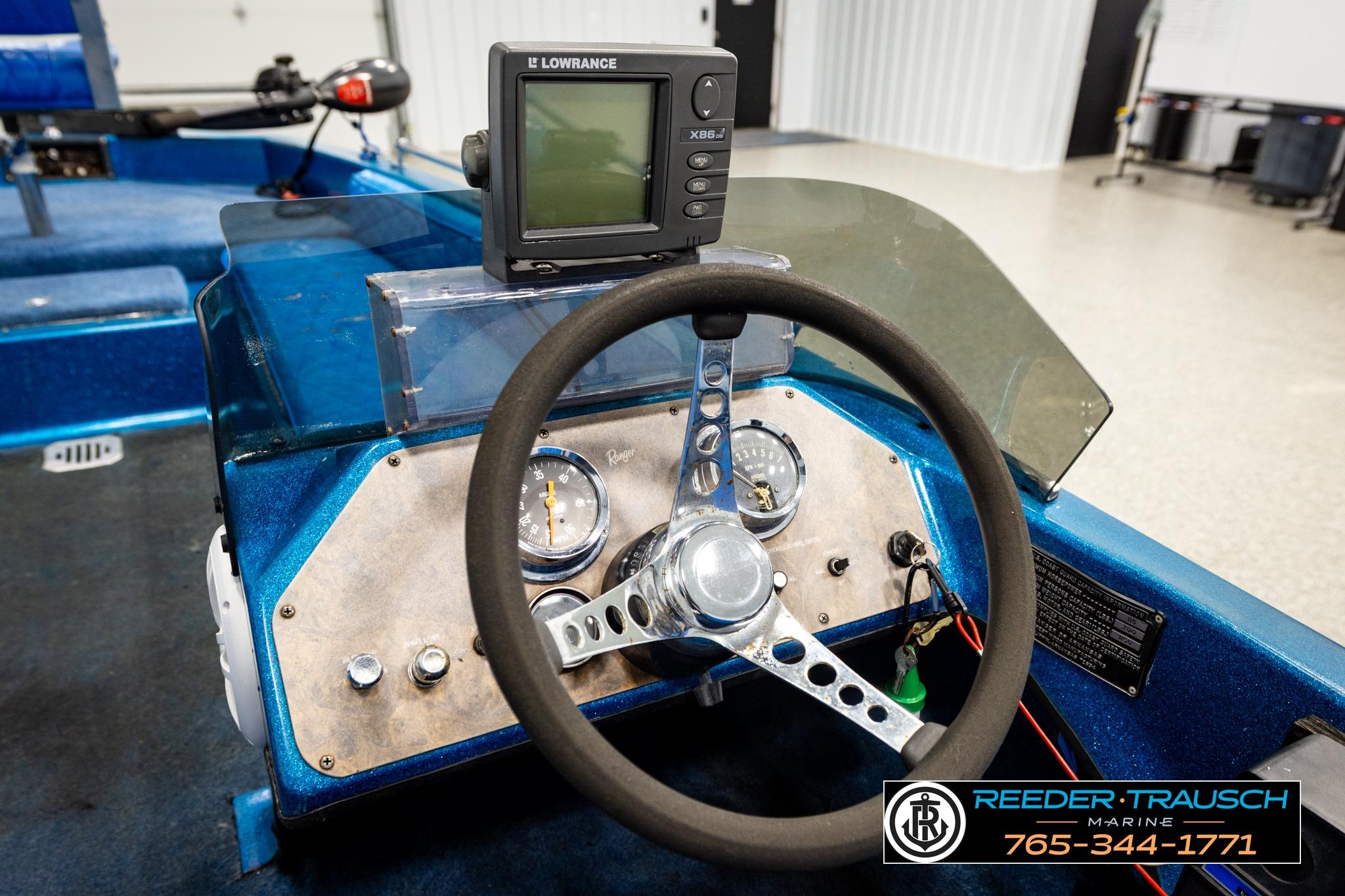 1980 Ranger 175 VS boat dashboard with steering wheel and Lowrance fish finder.