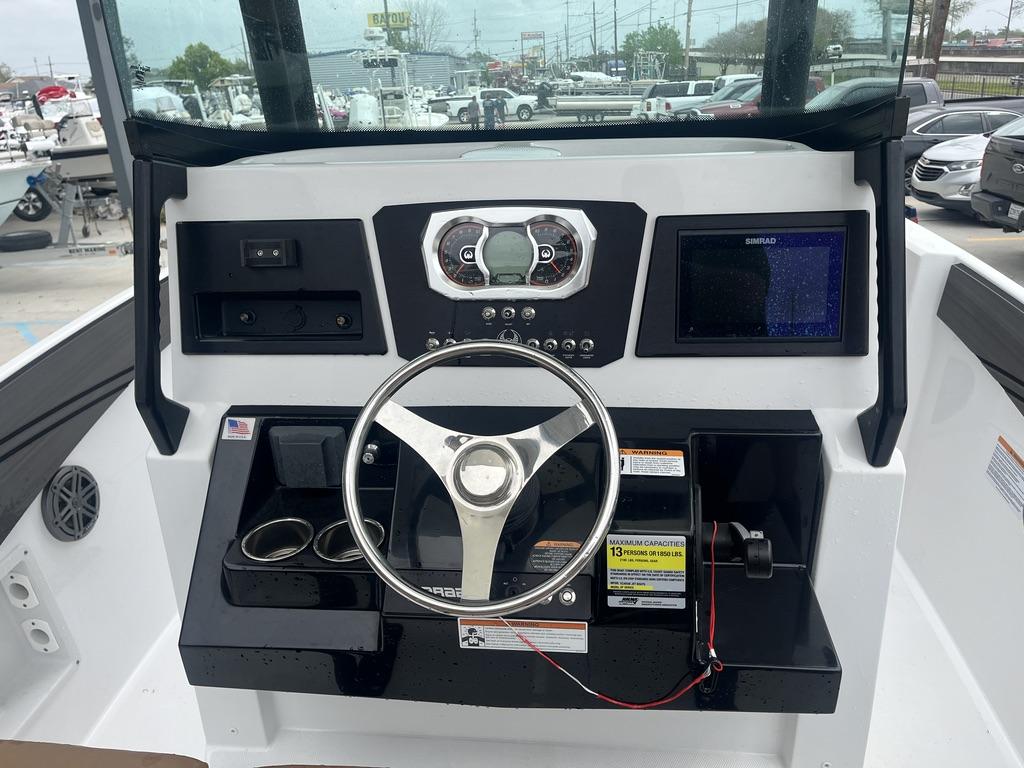 2022 Scarab 255 Open ID boat dashboard with steering wheel and control panel.