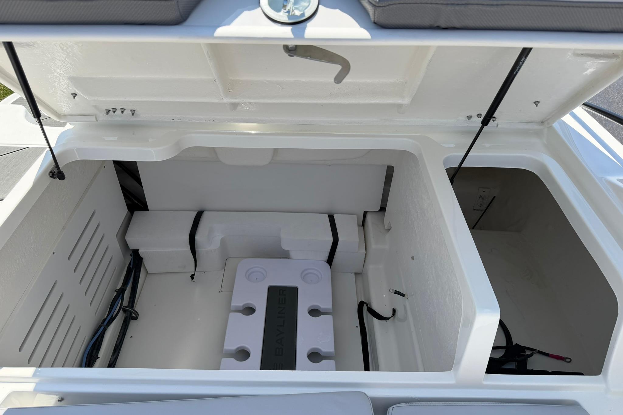 Open storage compartment of 2026 Bayliner D20 boat, showcasing interior design and features.