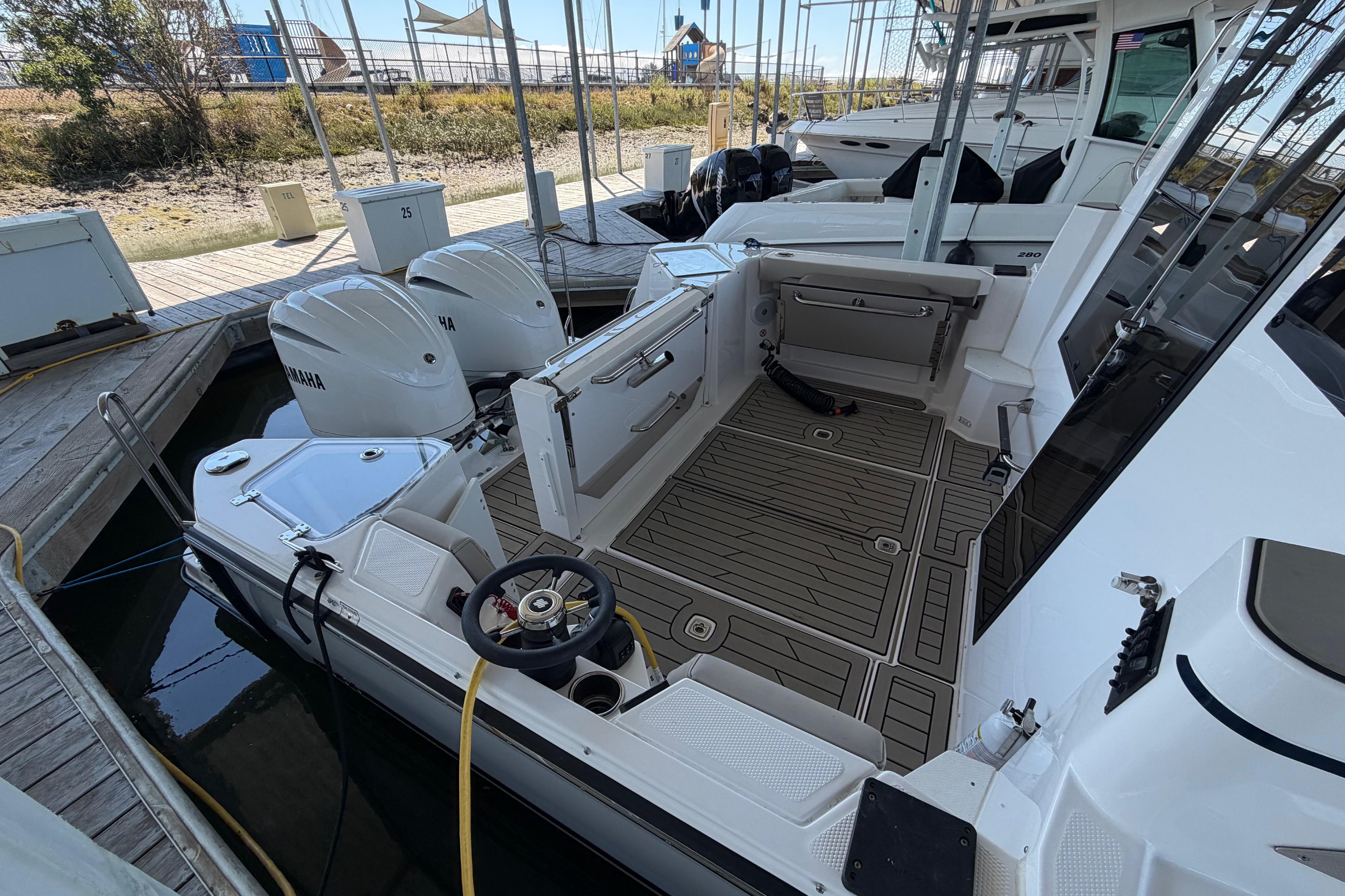 2023 Cutwater C-288 Coupe boat with Yamaha engines docked at marina.