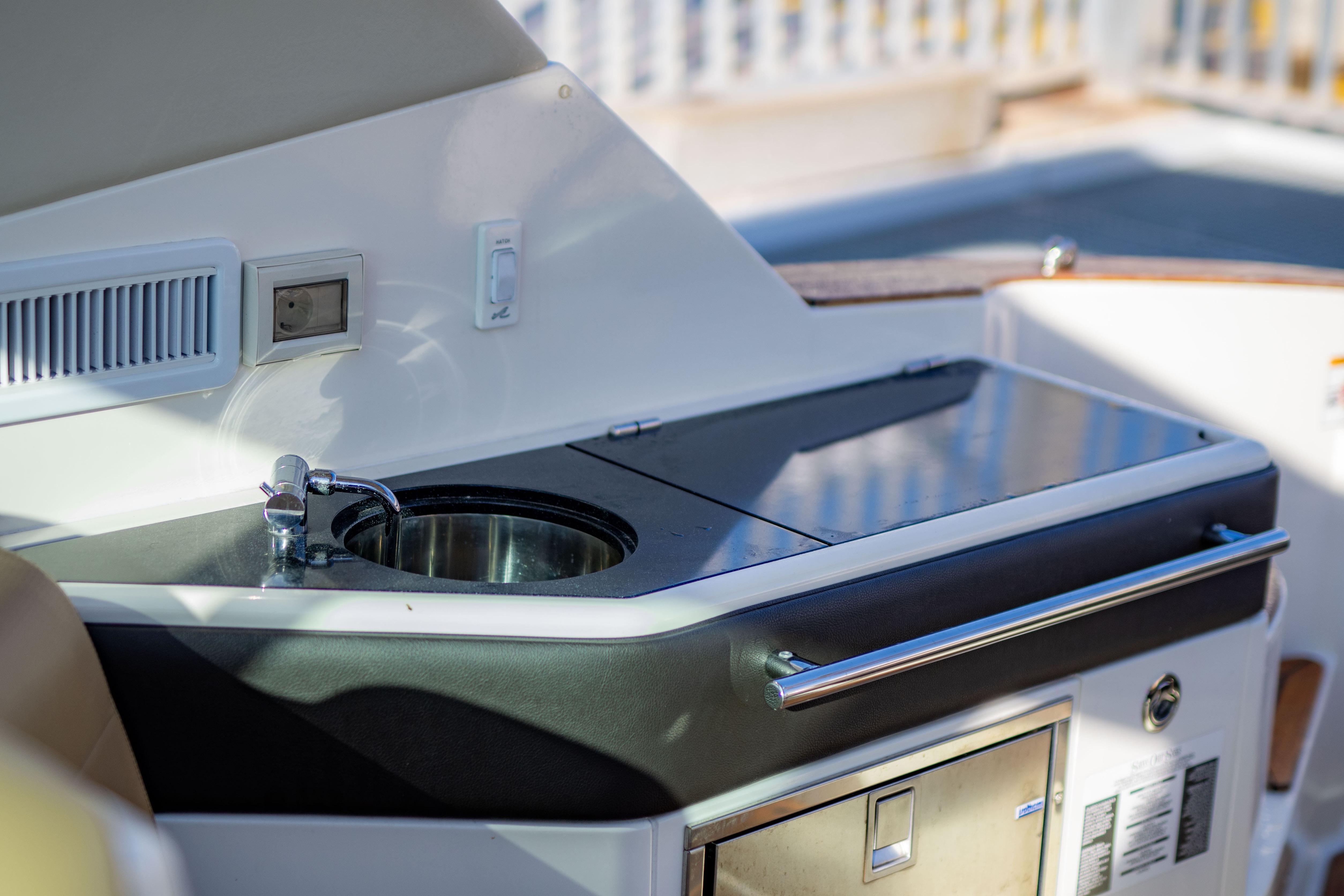 2022 Sea Ray Sundancer 320 yacht kitchenette with sink and storage.