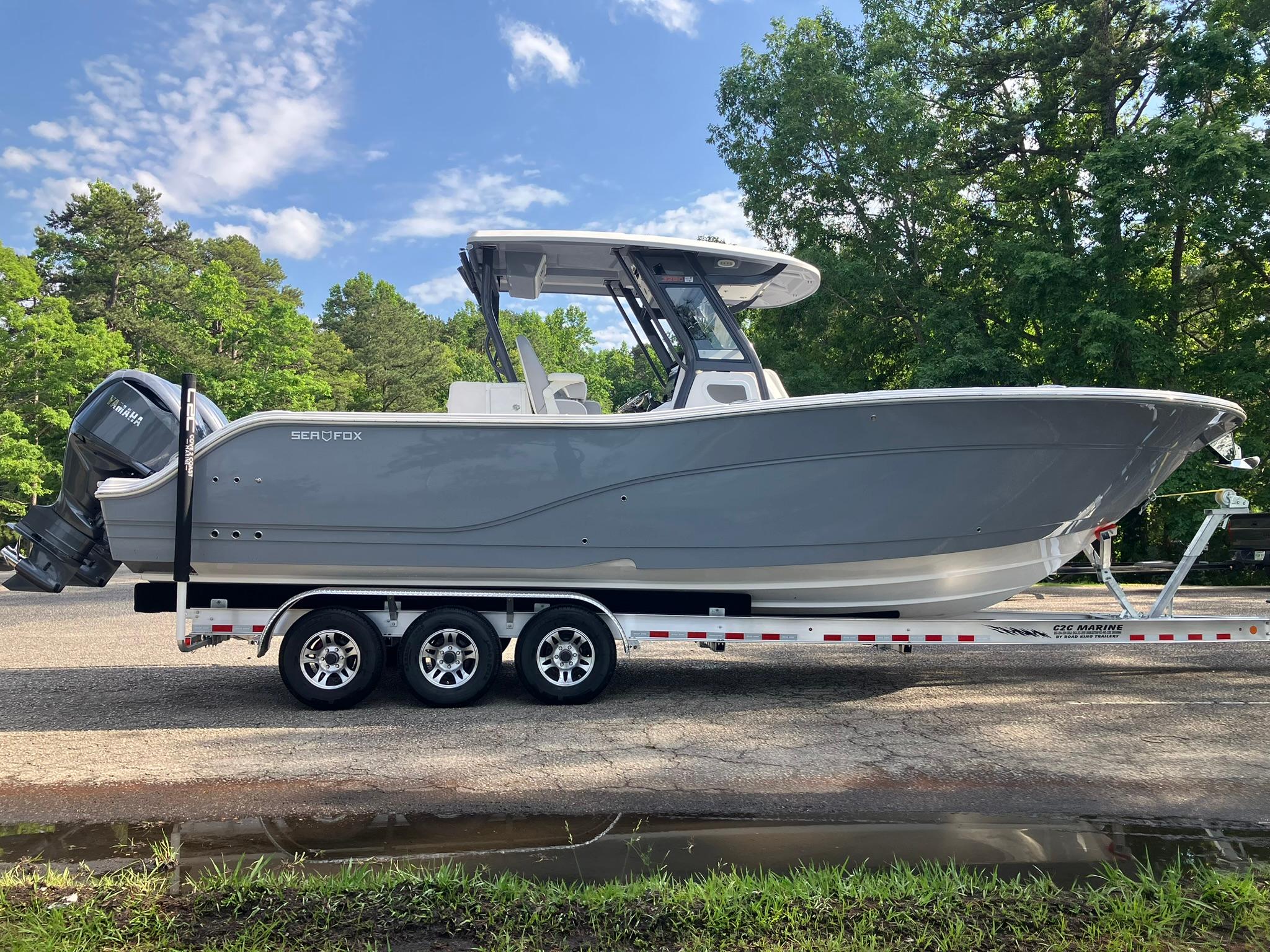 2025 Sea Fox 328 Commander boat on trailer, parked outdoors.