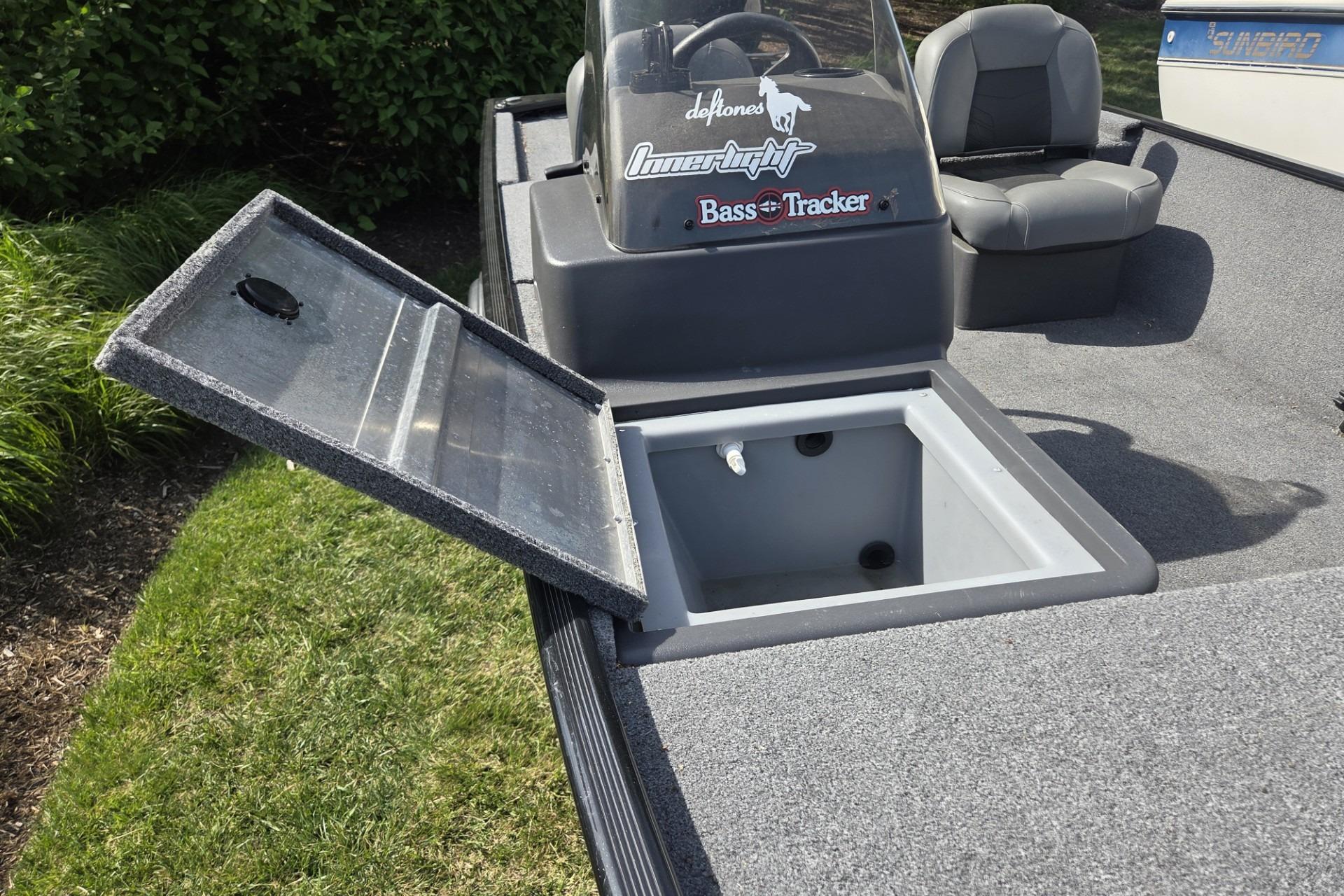 2024 TRACKER MARINE CLASSIC XL boat with open storage compartment and seating.