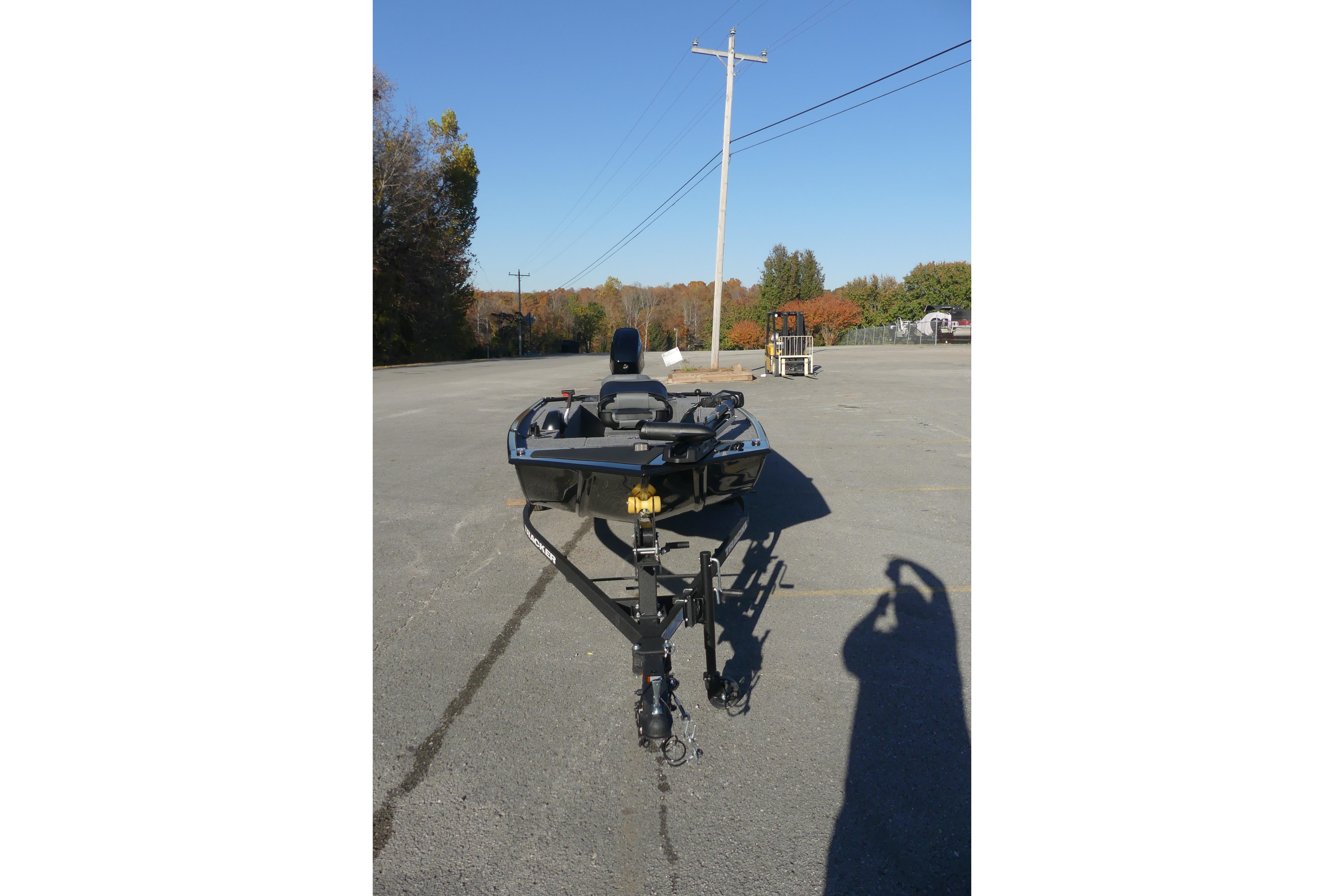 2025 Tracker Panfish 17 boat on trailer in parking lot, clear sky background.