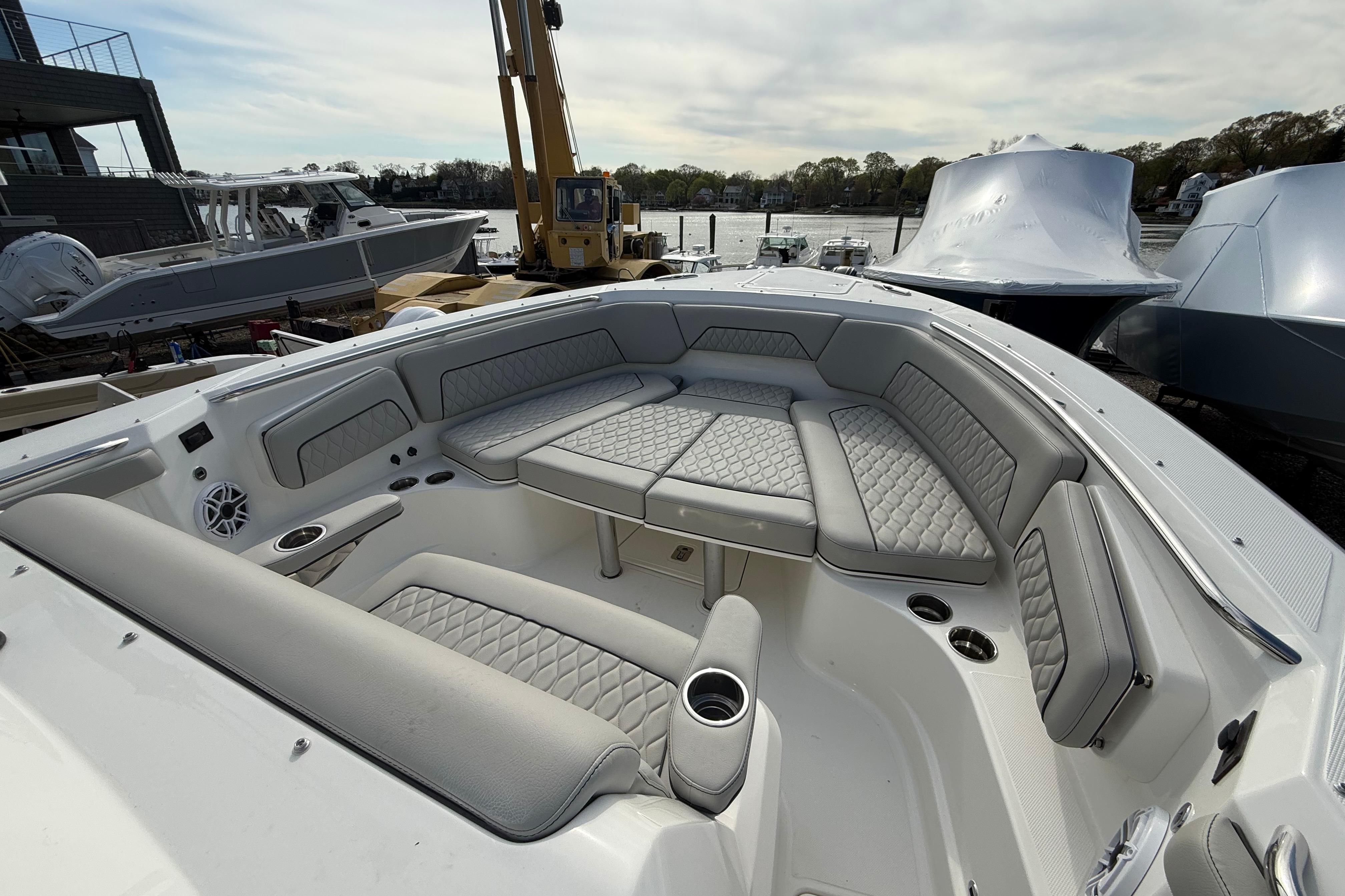 2026 Pursuit S 328 Sport boat with luxurious seating and modern design at a marina.