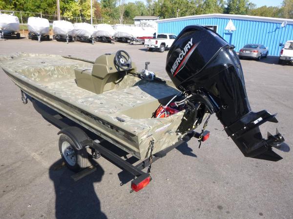 2024 Tracker Grizzly 1648 SC boat with Mercury outboard motor in parking lot.