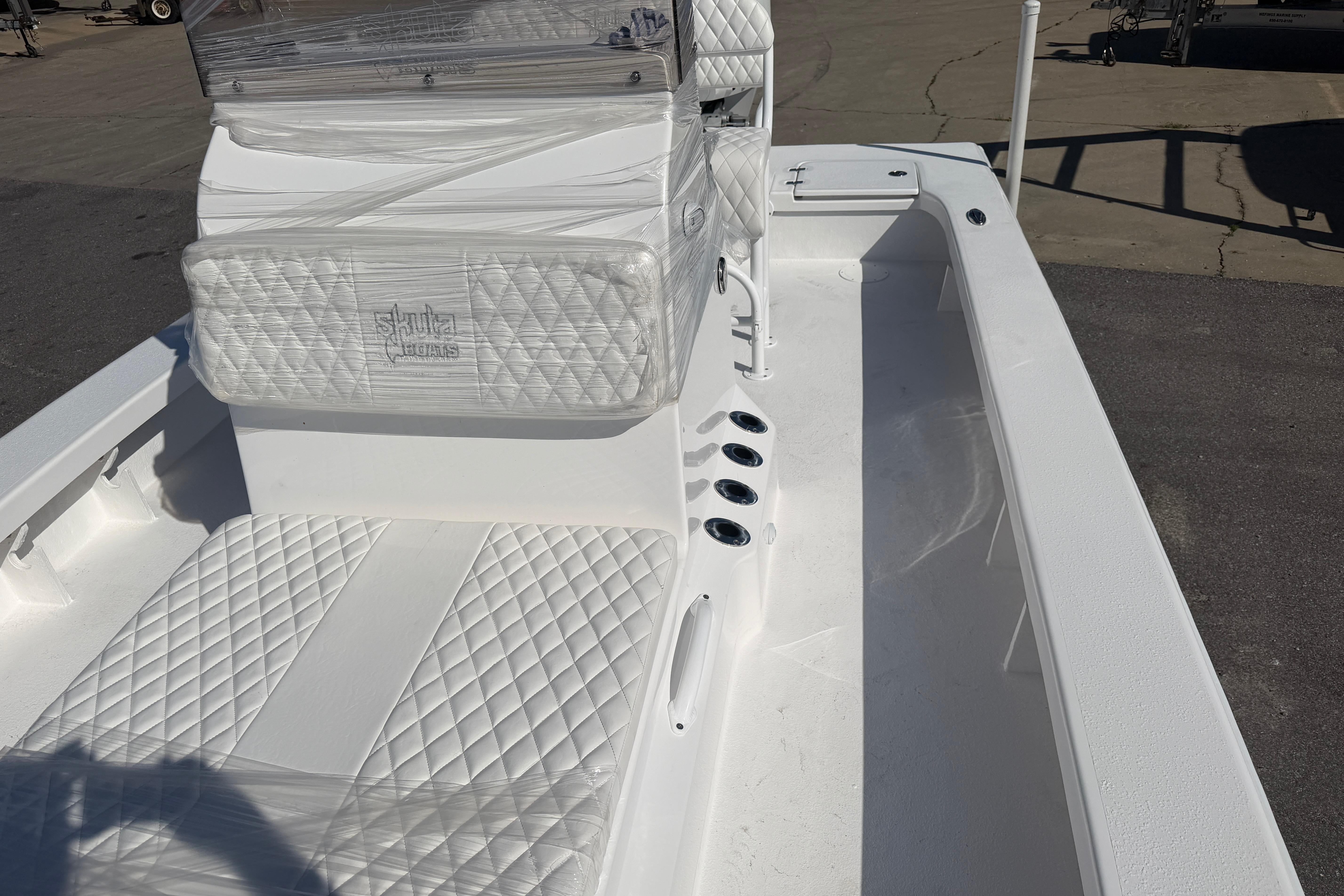 2026 Skuta 24 Cat boat interior with quilted white seating and sleek design.