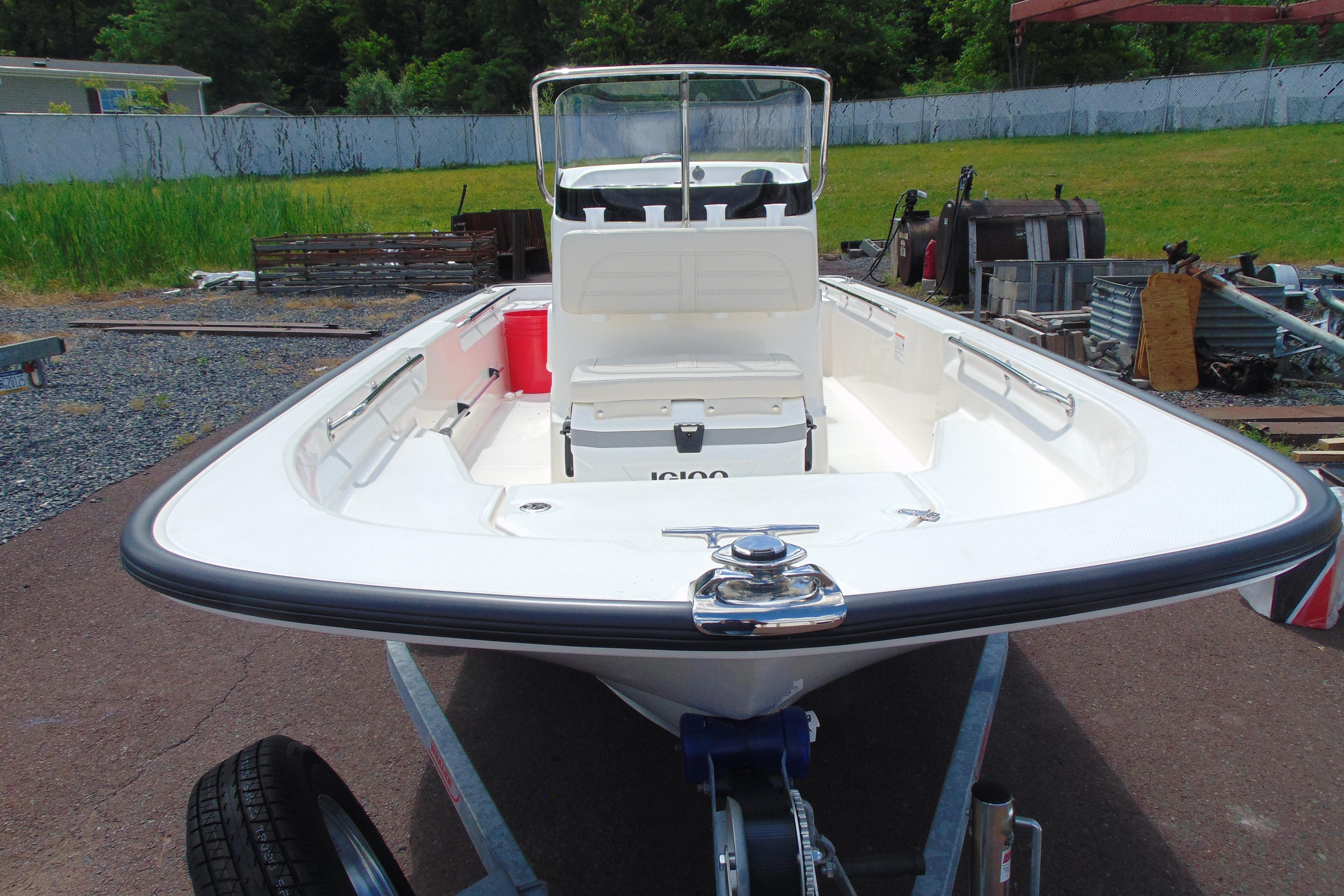 2026 Boston Whaler 150 Montauk boat on trailer, parked outdoors.