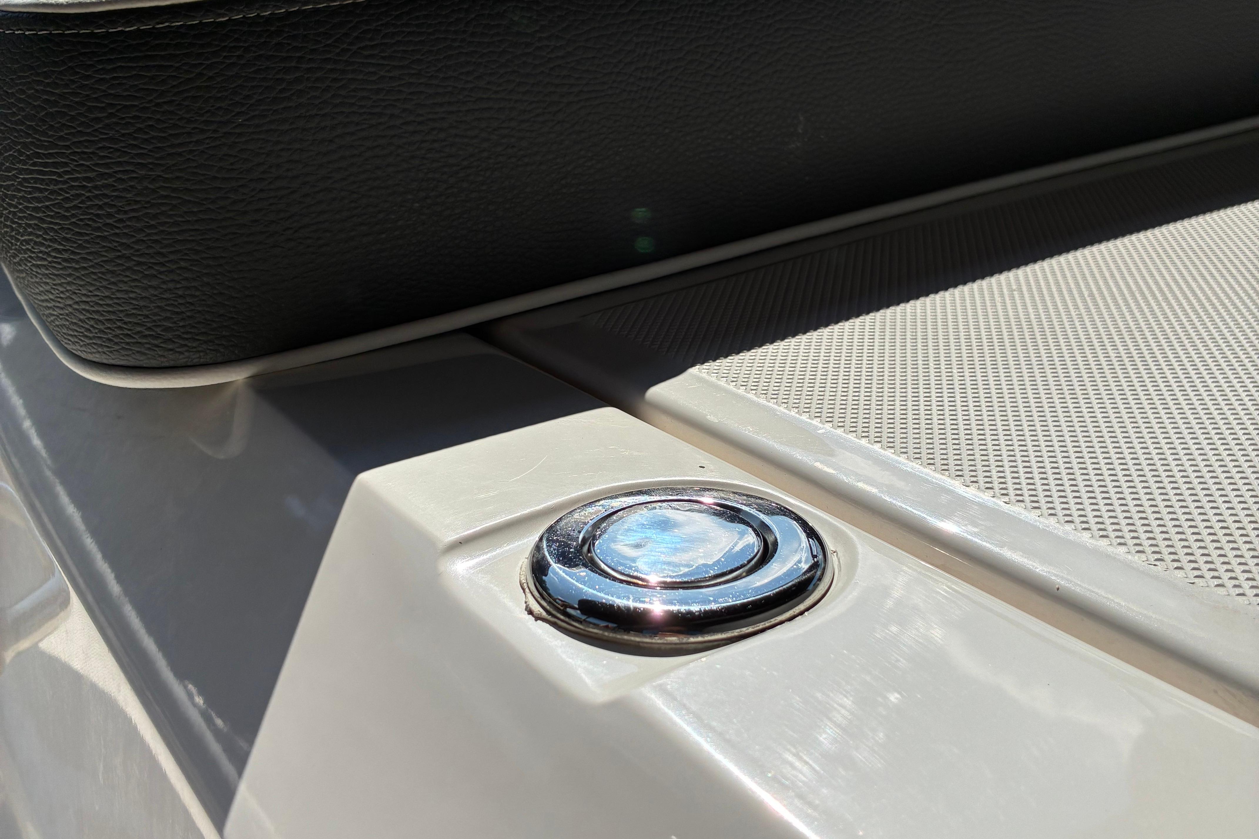 2025 Regal LS2 boat detail with chrome button and textured surface.