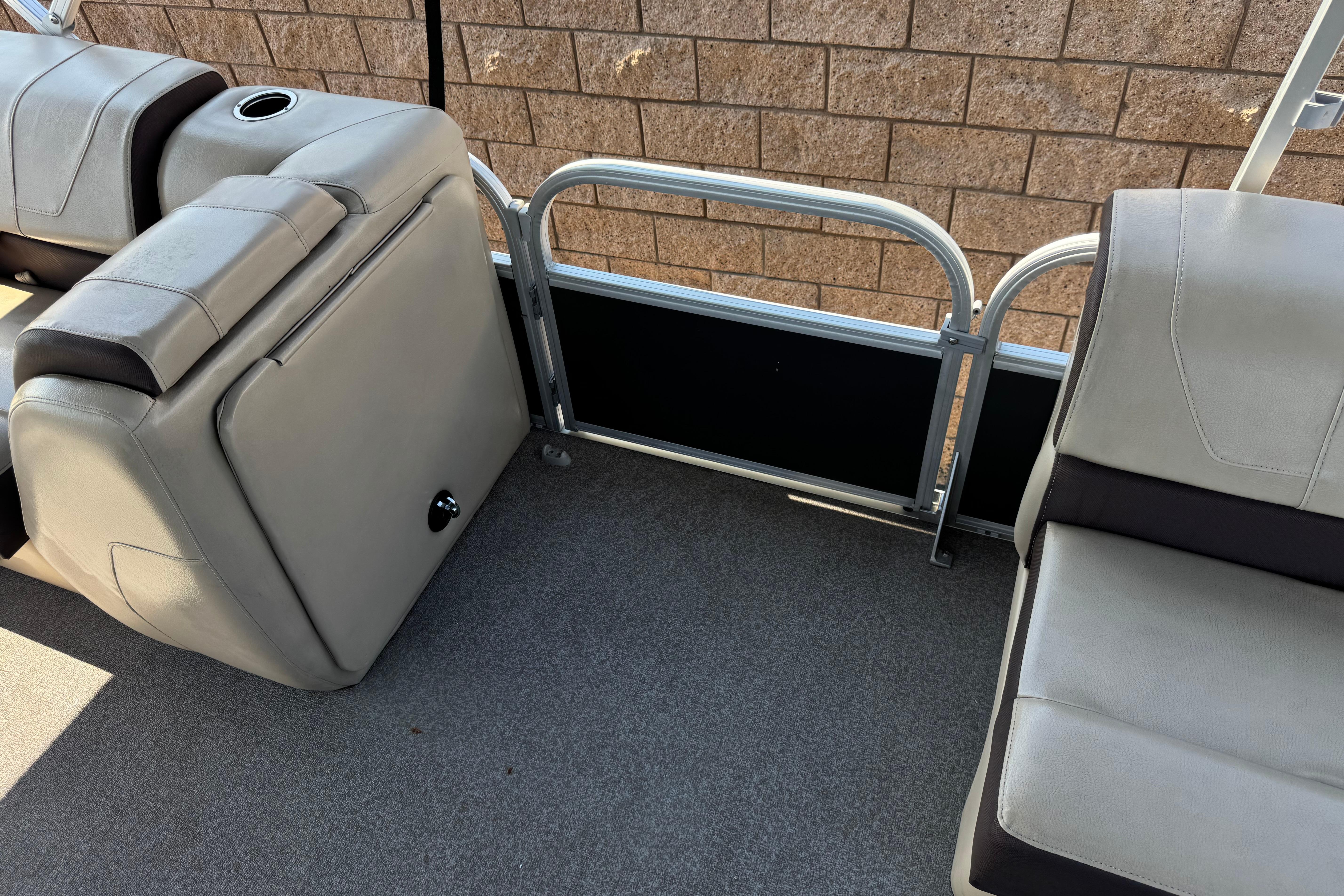 2018 Sun Tracker SportFish 22 DLX interior with gray seating and cup holder.