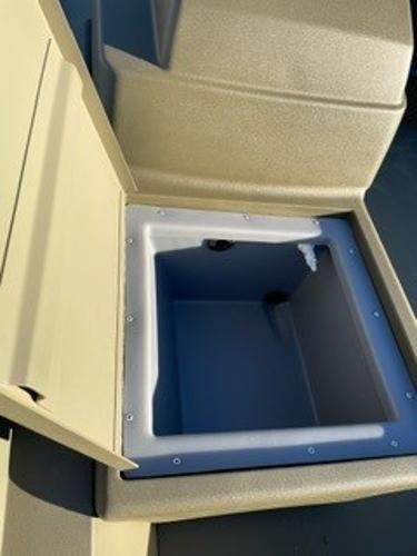 2024 Tracker Grizzly 1754 SC storage compartment, open lid, beige interior.