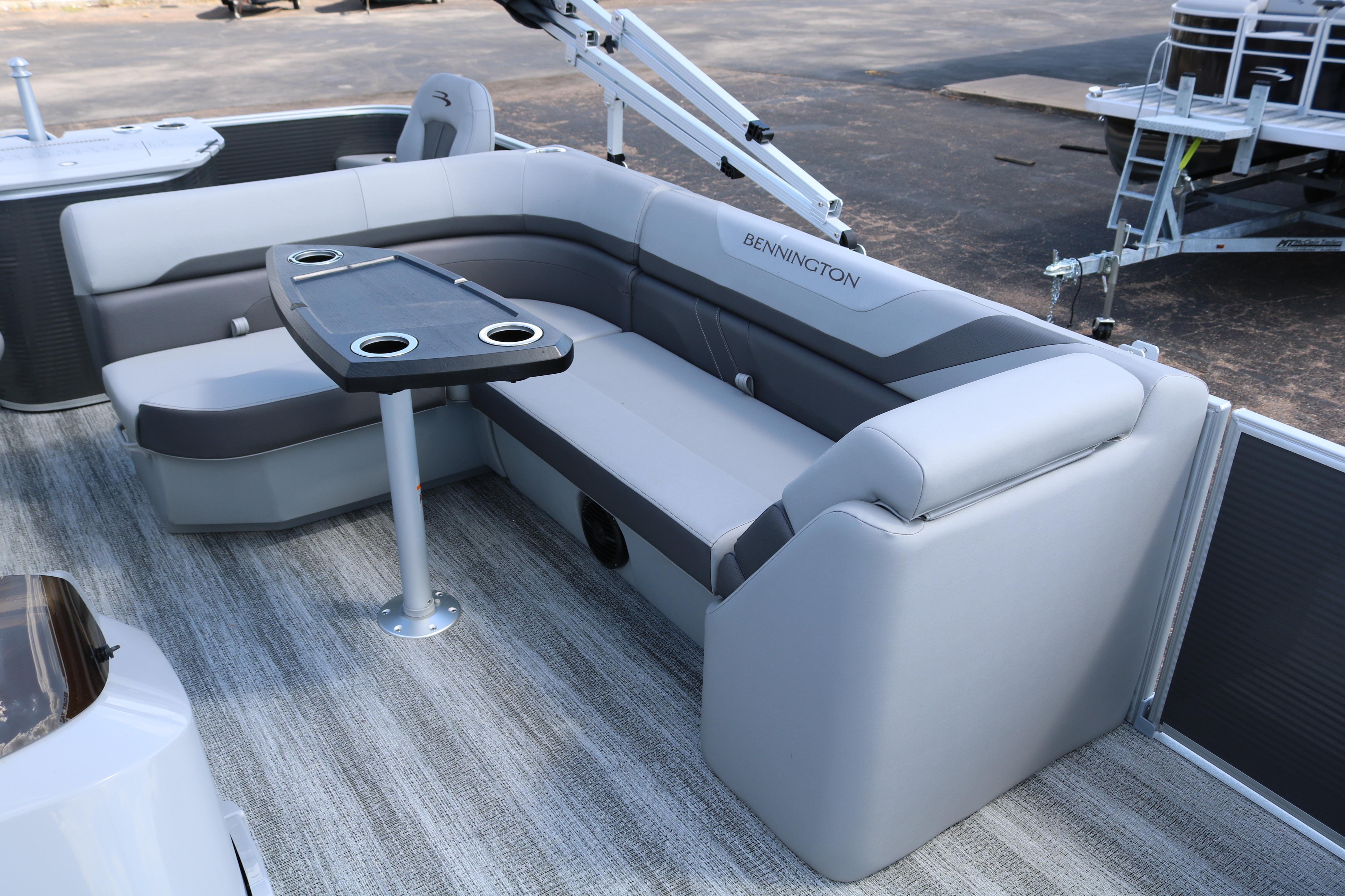 2026 Bennington 20SXSNP REAR FISH boat interior with gray seating and table.