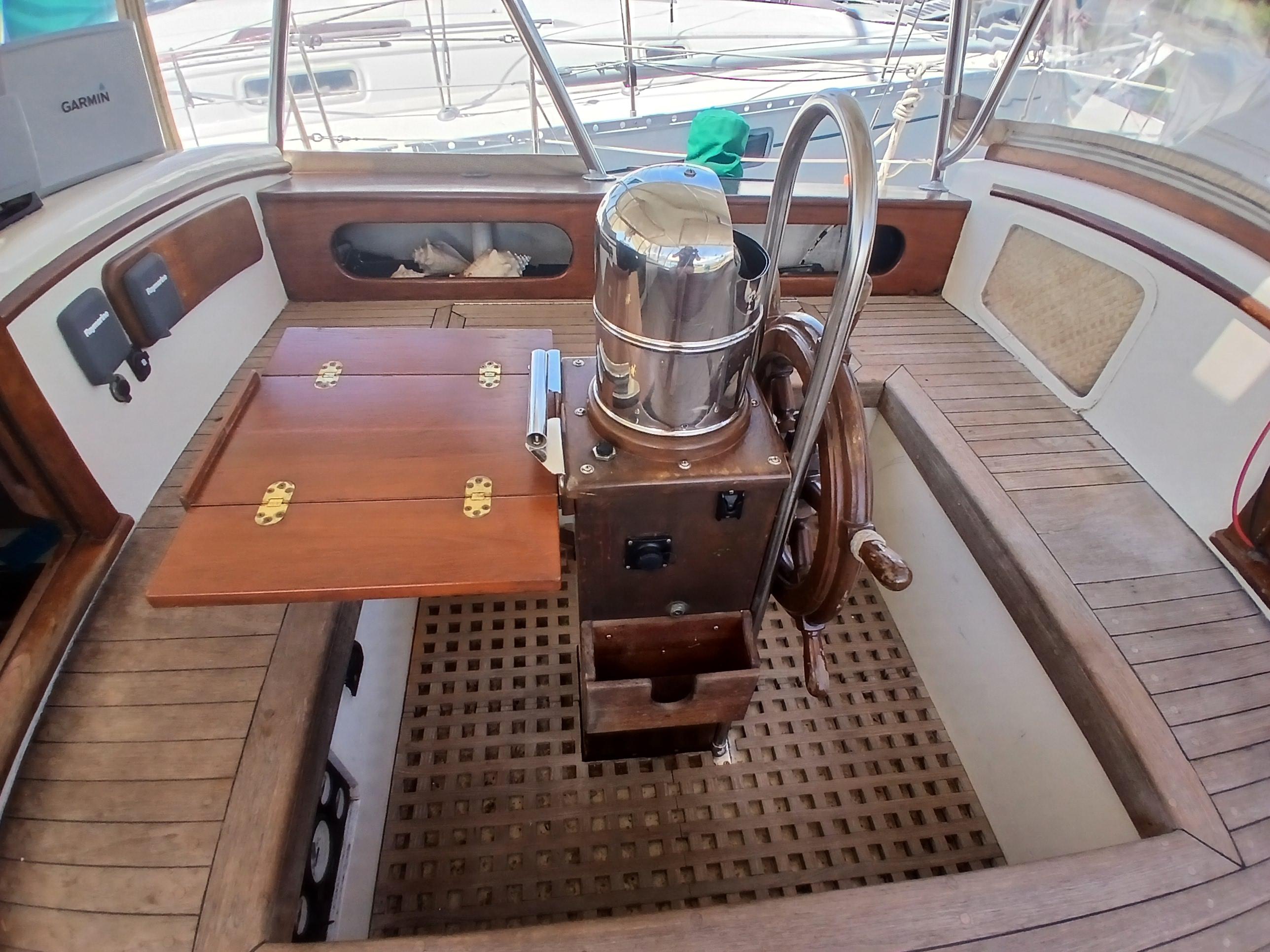 Cockpit of 1977 Dickerson 41 sailboat with wooden wheel and folding table.
