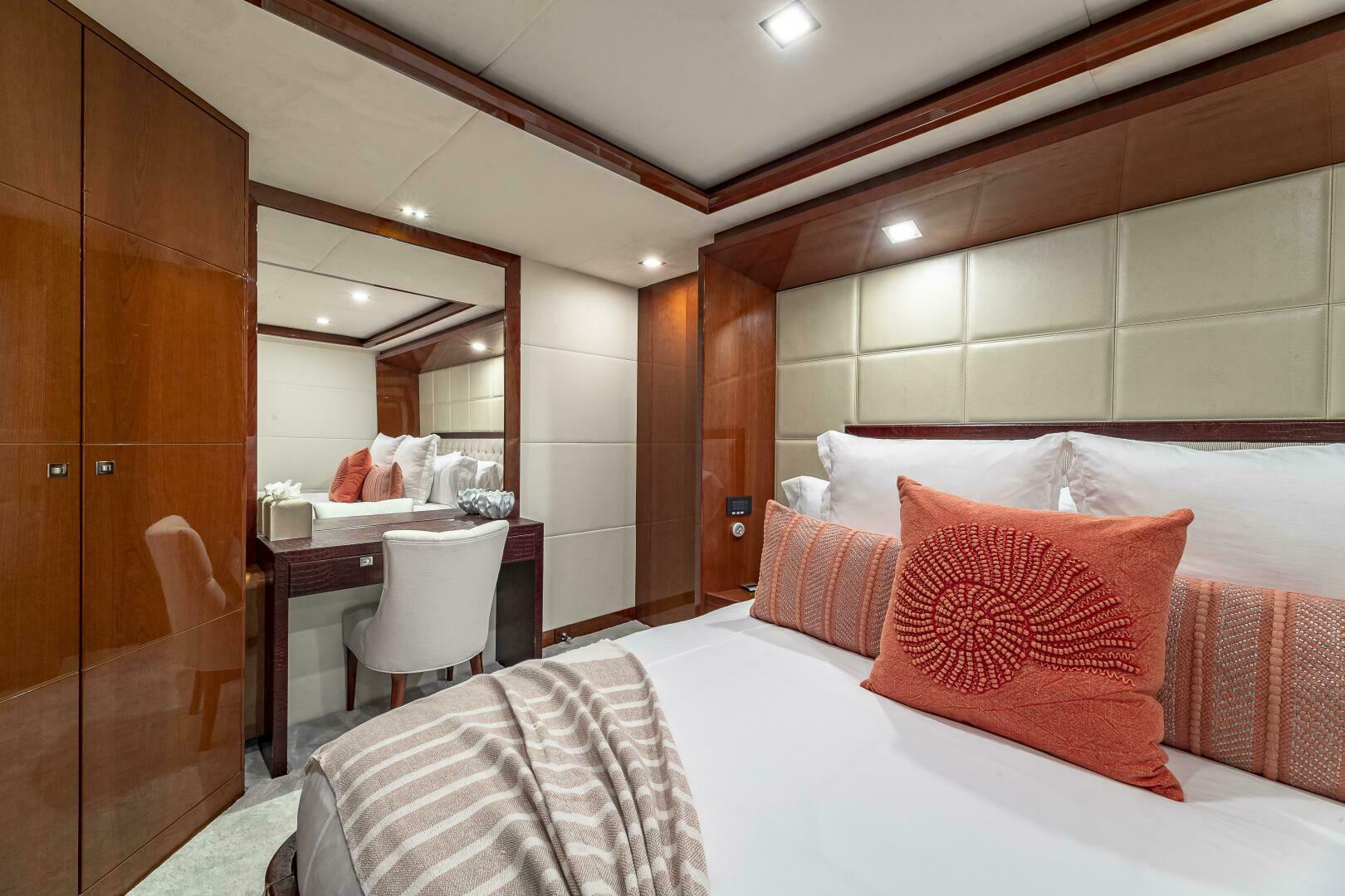 Luxurious bedroom interior of 2012 Princess 32M yacht with elegant decor and cozy bedding.
