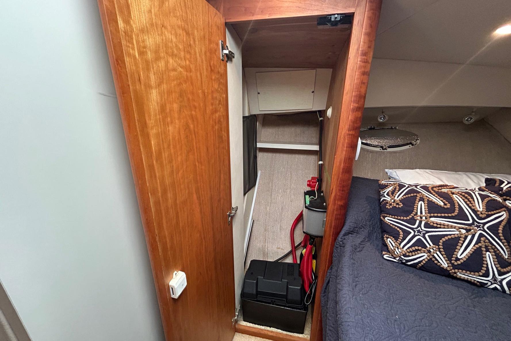 Interior of 2000 Silverton 352 Motor Yacht showing cabin storage and bedding.