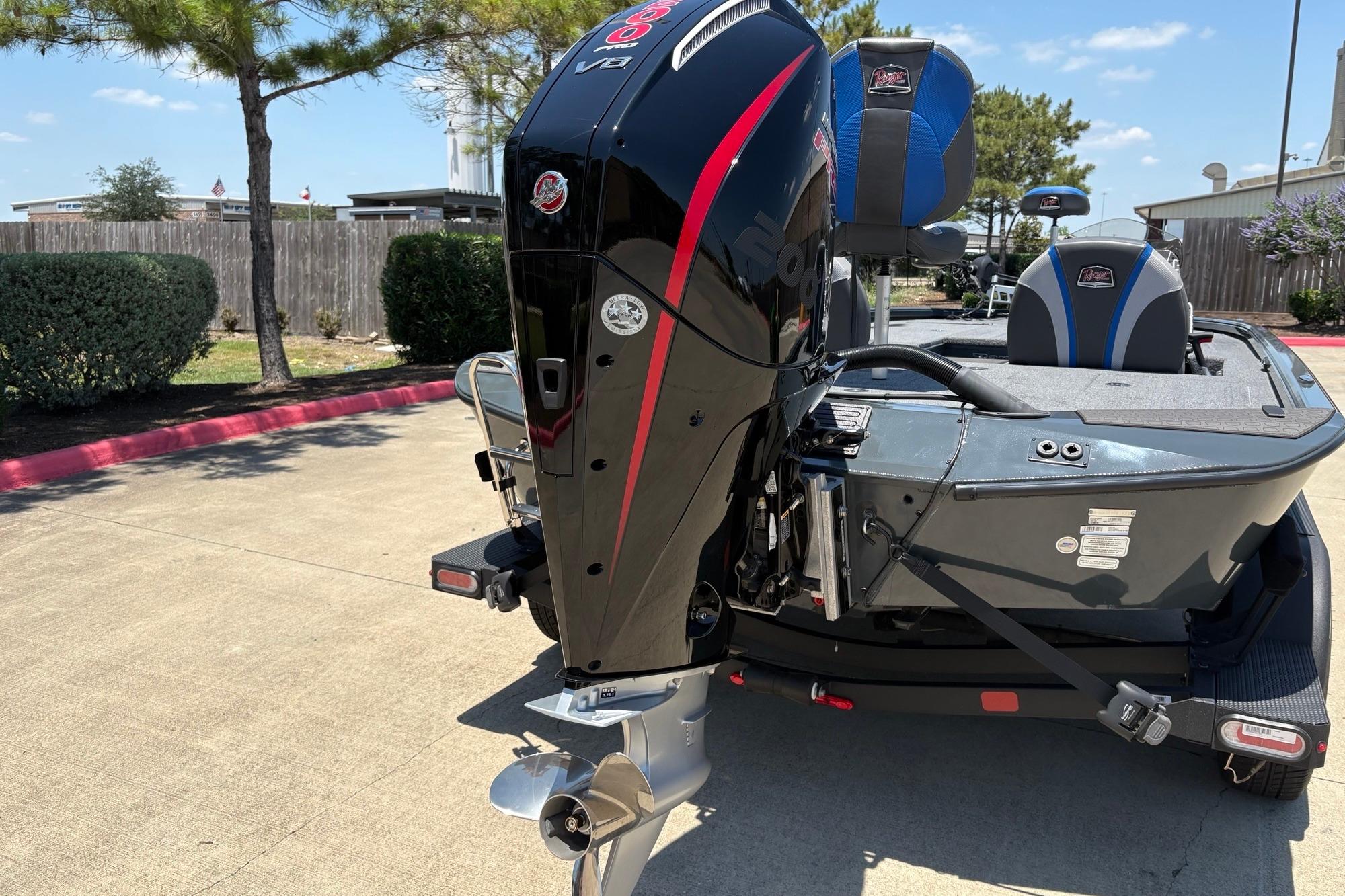 2025 Ranger ALPHA 208 boat with powerful outboard motor in sunny outdoor setting.
