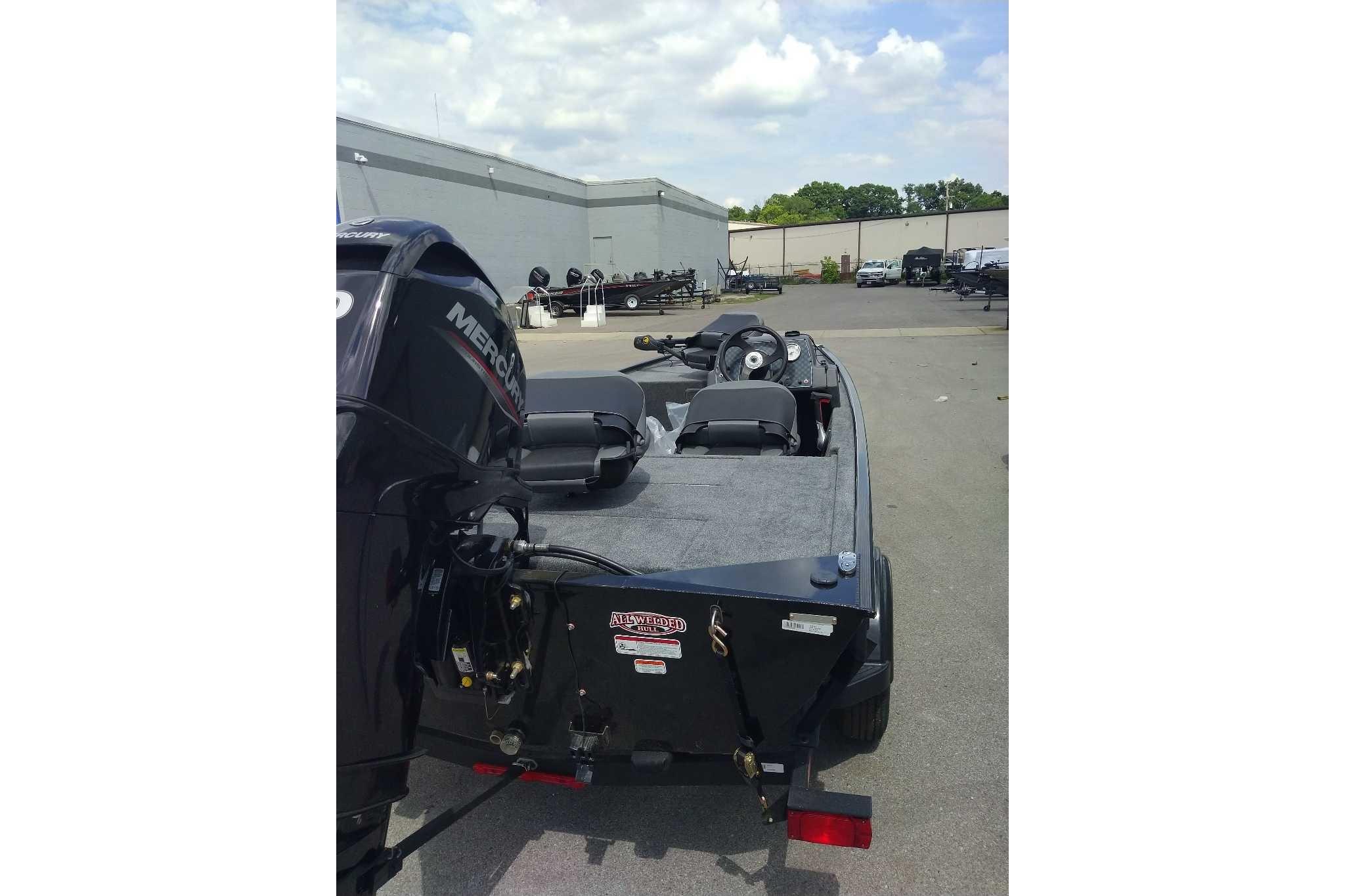 2026 Tracker Bass Tracker Classic XL boat with Mercury engine in a parking lot.