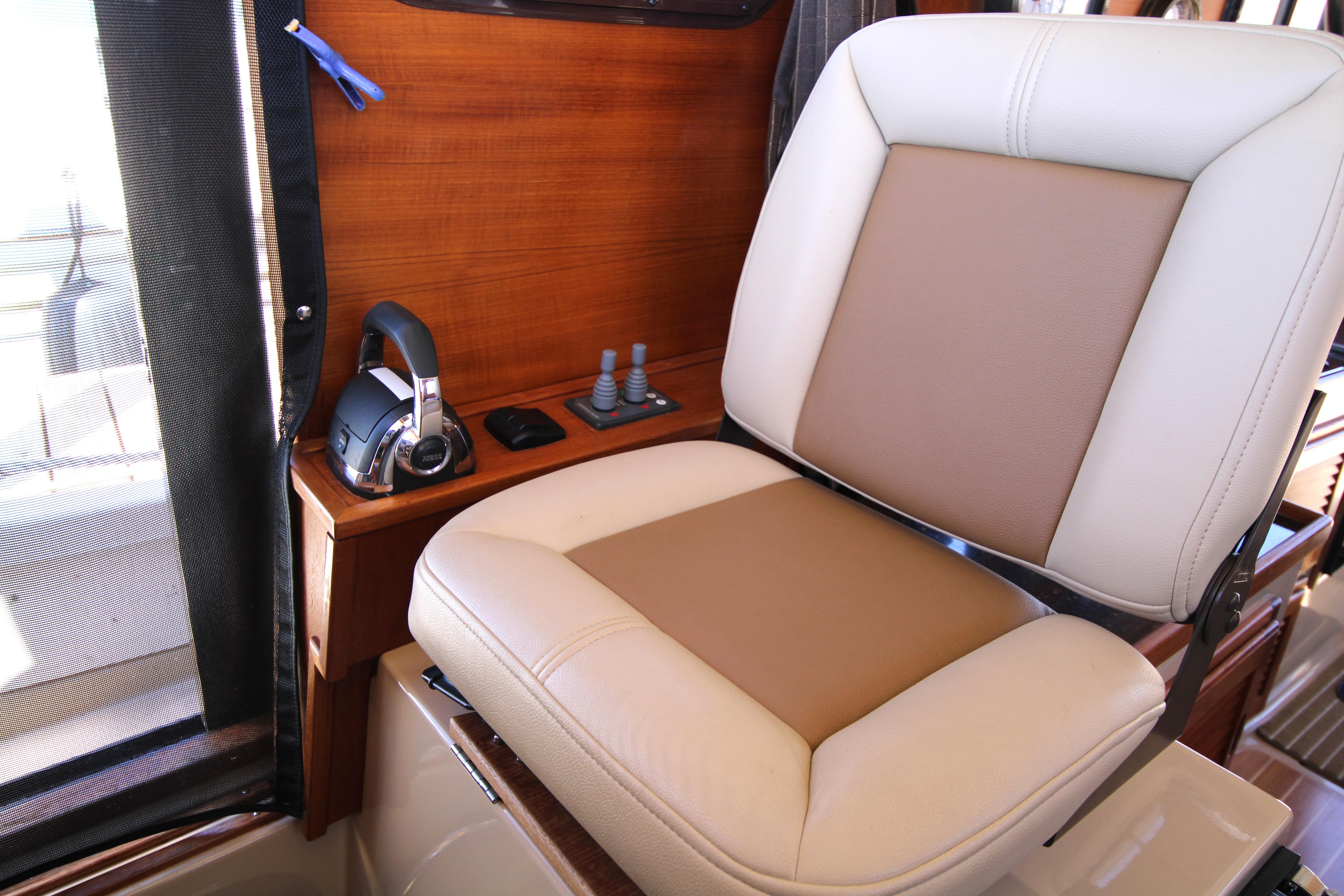 Captain's chair and controls in 2013 Ranger Tugs R-31 CB boat interior.