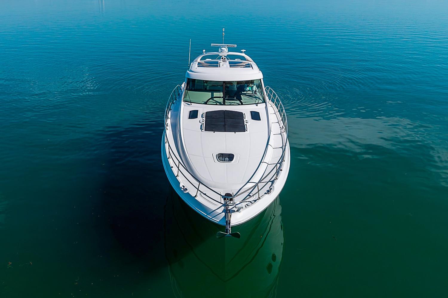 2008 Sea Ray 60 Sundancer yacht on calm blue water, aerial view.
