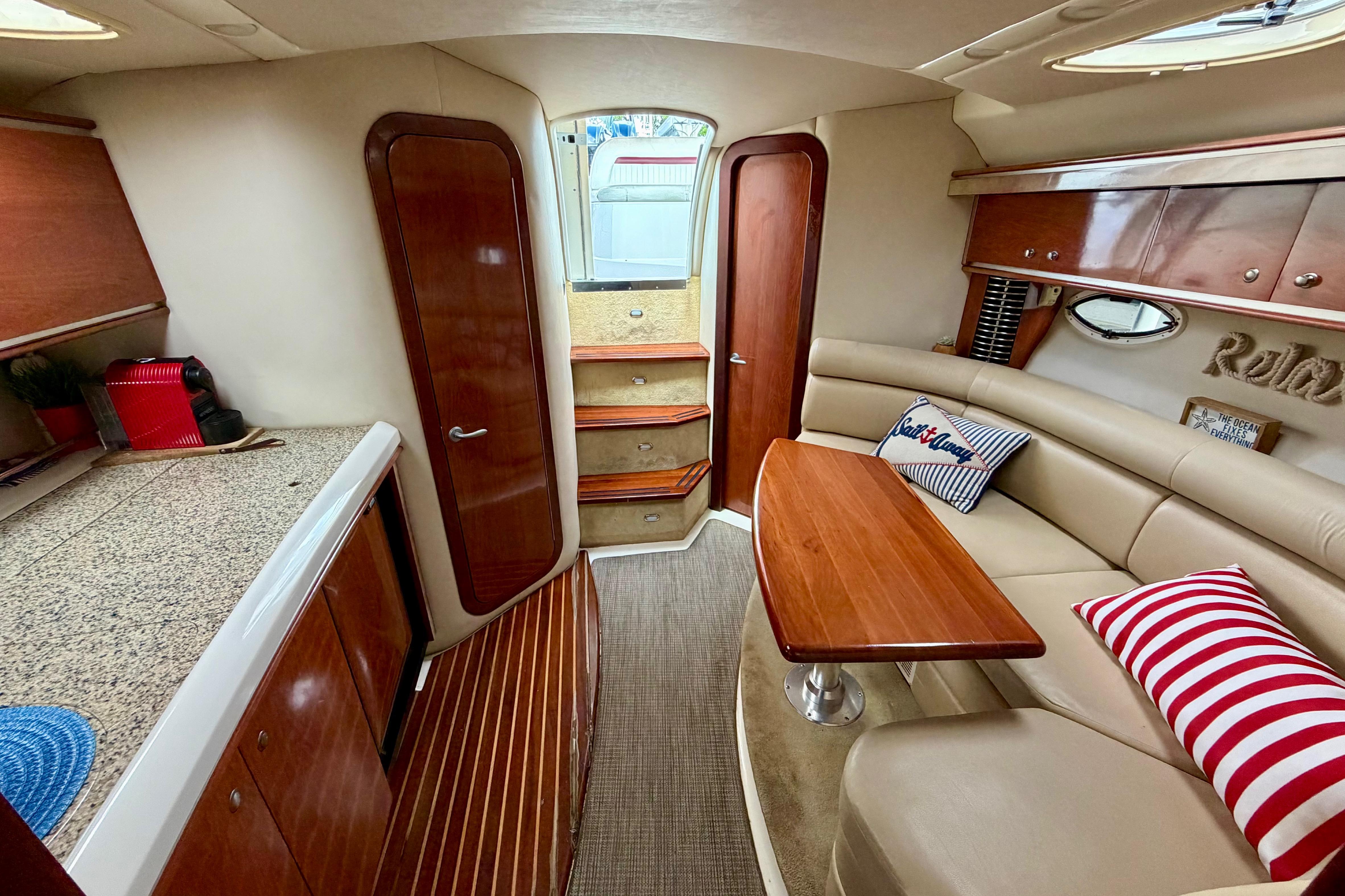 Luxurious interior of 2007 Monterey 350 Sport Yacht with elegant wood finishes and cozy seating.